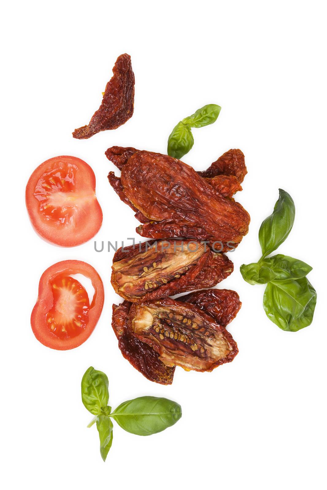 Sundried tomatos, fresh tomatoes and fresh basil herbs isolated on white background, top view. Culinary italian eating.