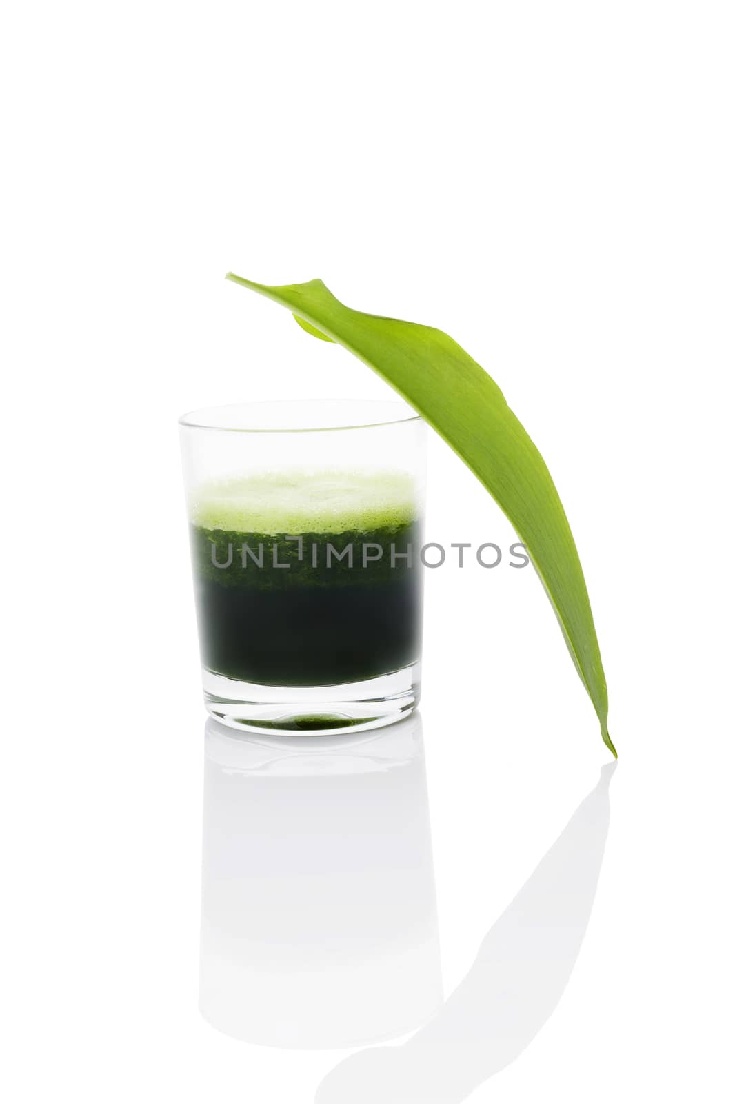 Green juice made from wild garlic with fresh wild garlic leaf isolated on white background. Spring detox, modern minimal style image. 