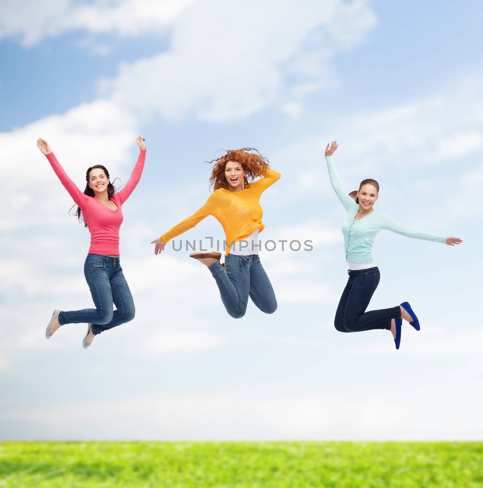 happiness, freedom, friendship, summer and people concept - group of smiling young women jumping in air over natural background