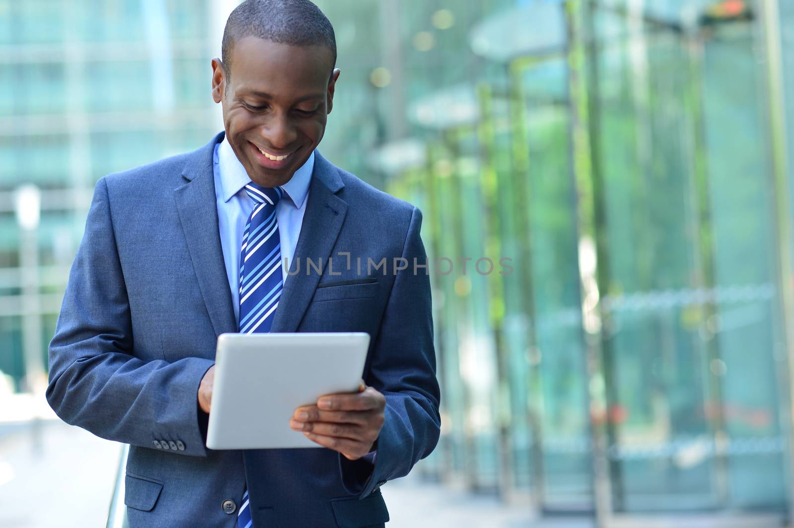 Businessman with digital tablet by stockyimages