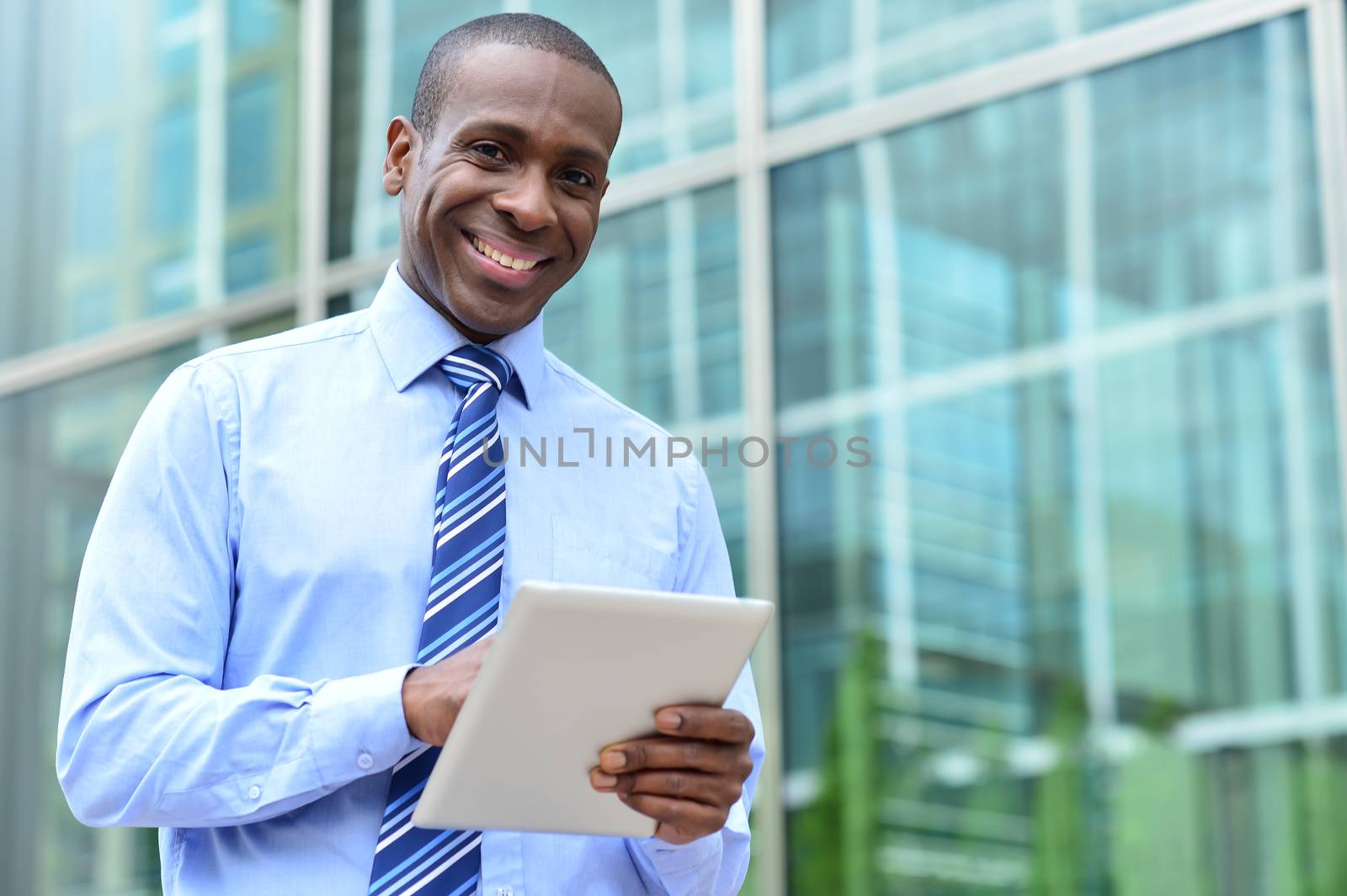 Middle aged businessman using tablet at outdoors