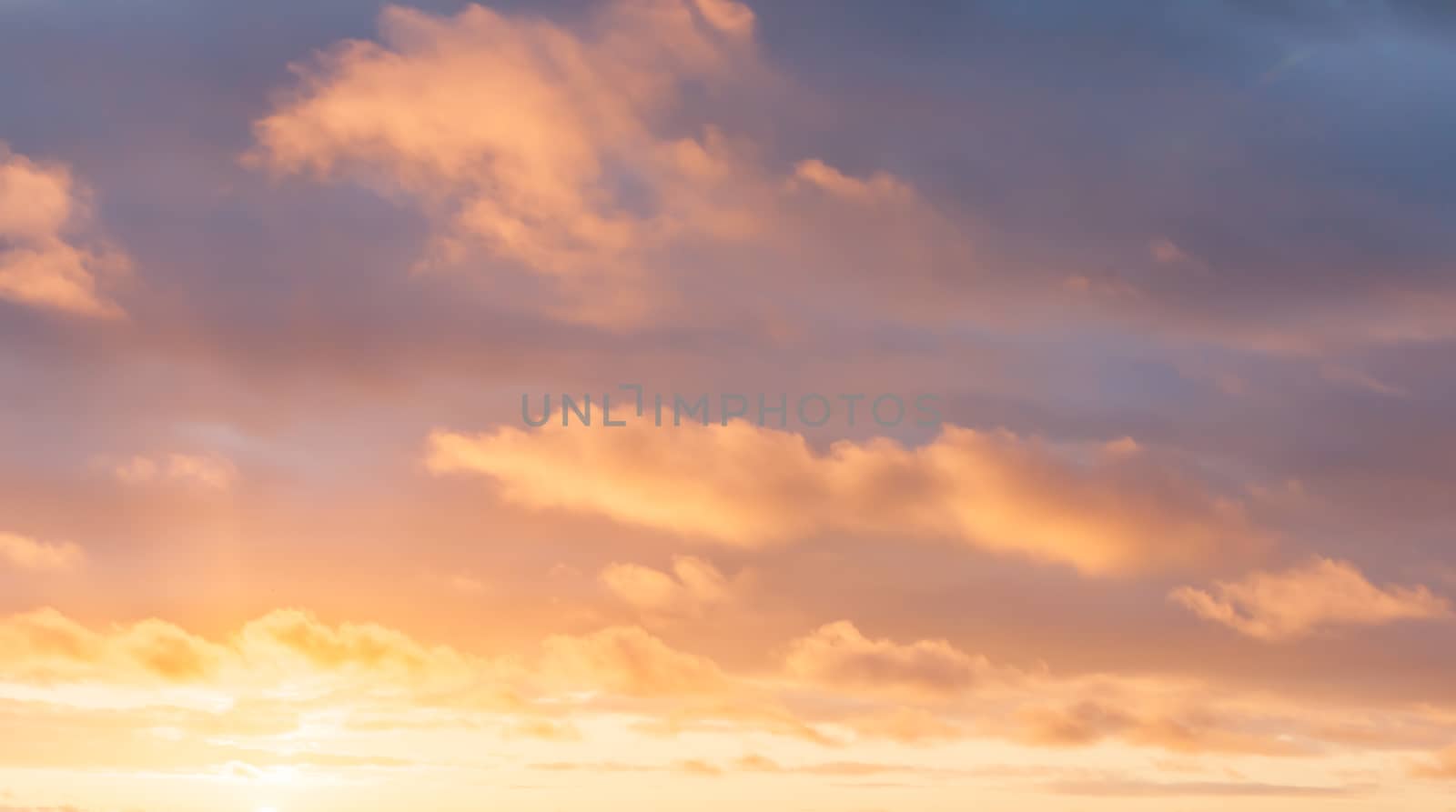 Bright cloudscape background with colors from golden through to blue.