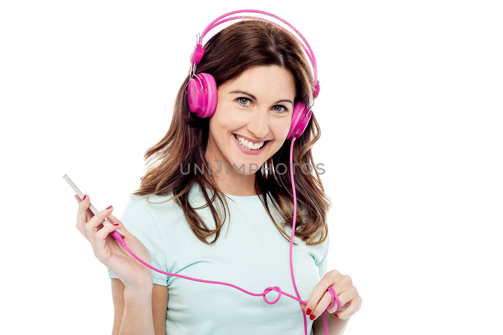 Happy woman listening music from mobile phone