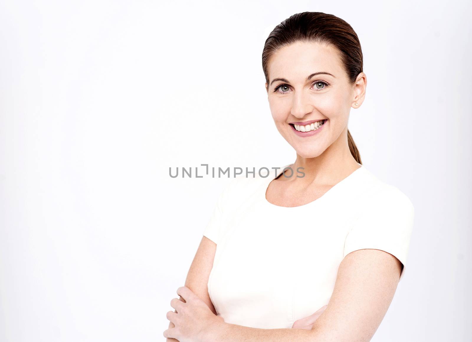 Pretty middle aged woman posing with folded arms