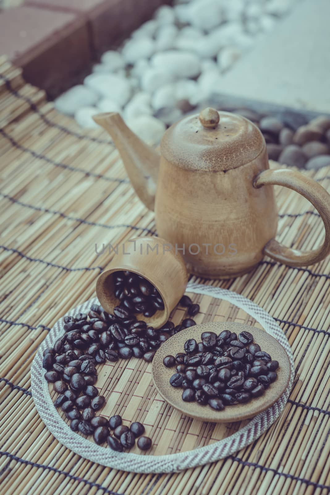 Coffee beans and coffee cup set on bamboo wooden background.Photo in retro color image style, Soft focus.