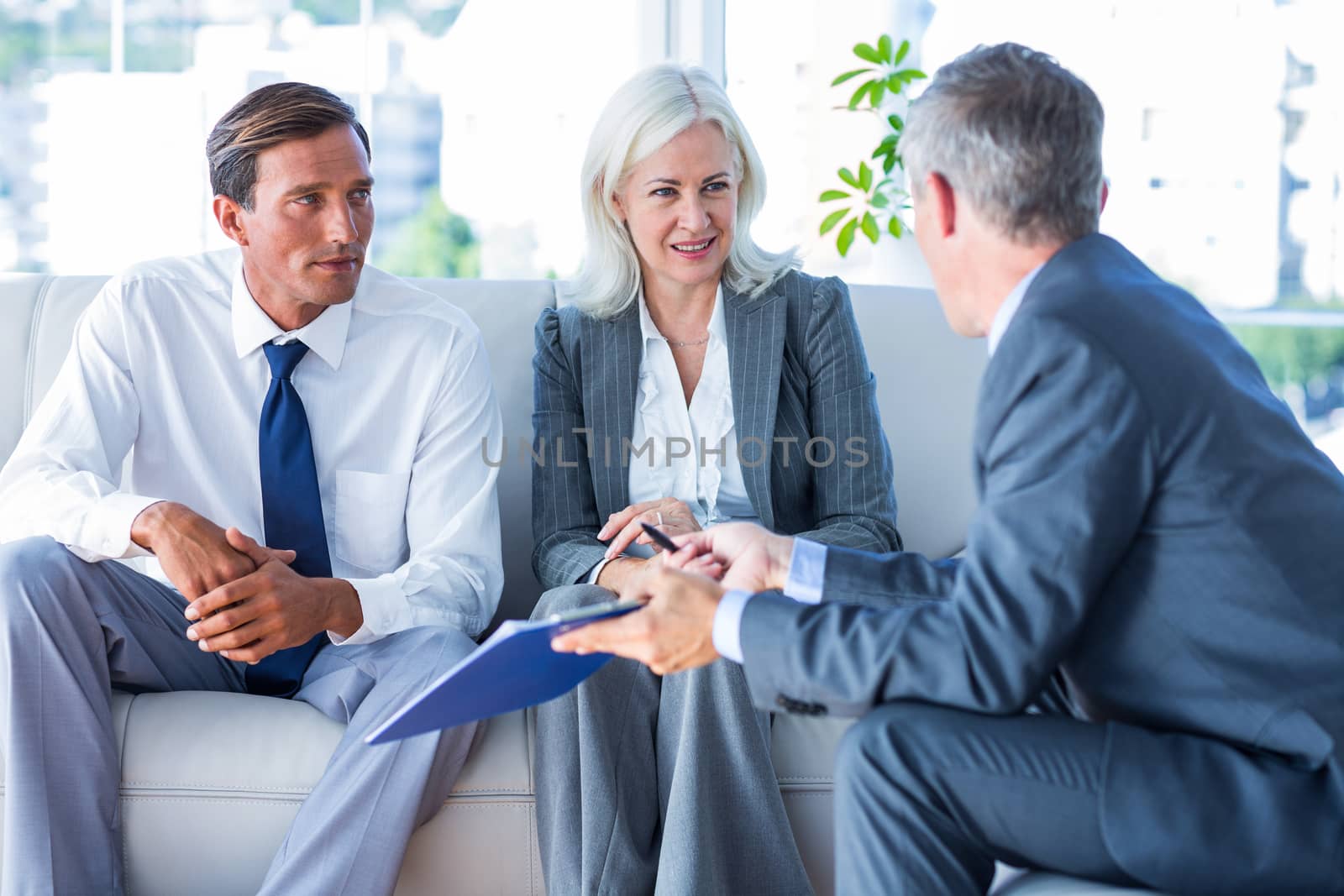 Business people speaking together on couch  by Wavebreakmedia