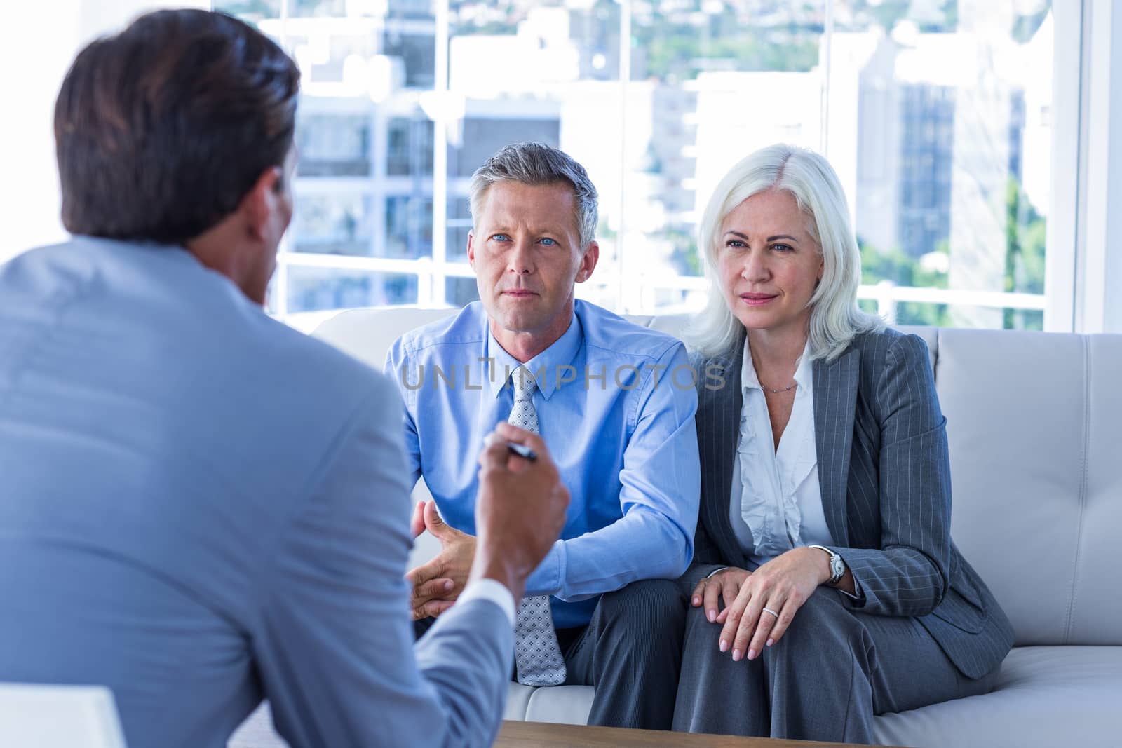 Business people speaking together on couch in office 