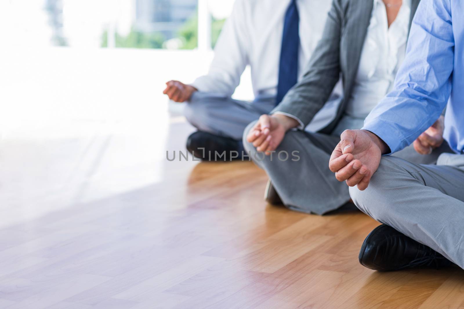 Close up view of business people doing yoga  by Wavebreakmedia