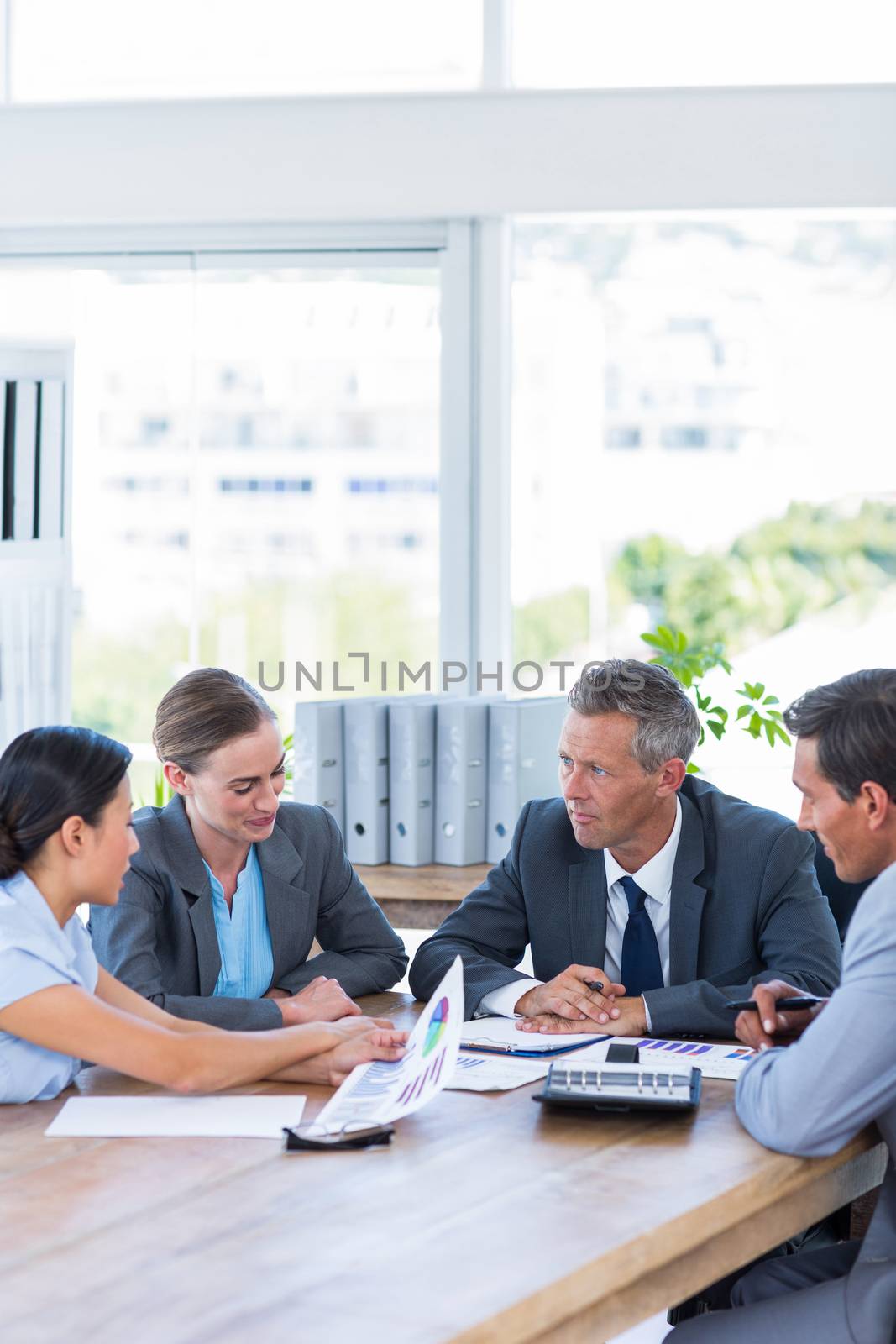 Business people speaking together during meeting in office