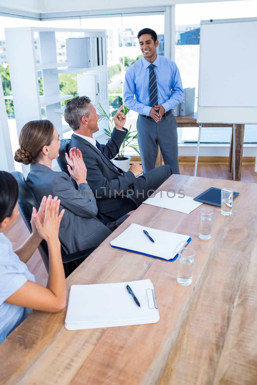 Business people applauding during a meeting by Wavebreakmedia