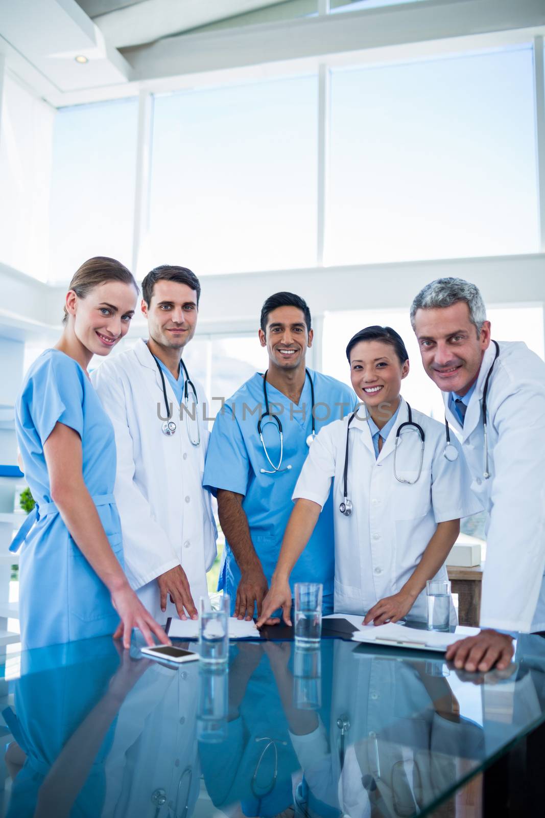 Doctors and nurses smiling at camera in medical office