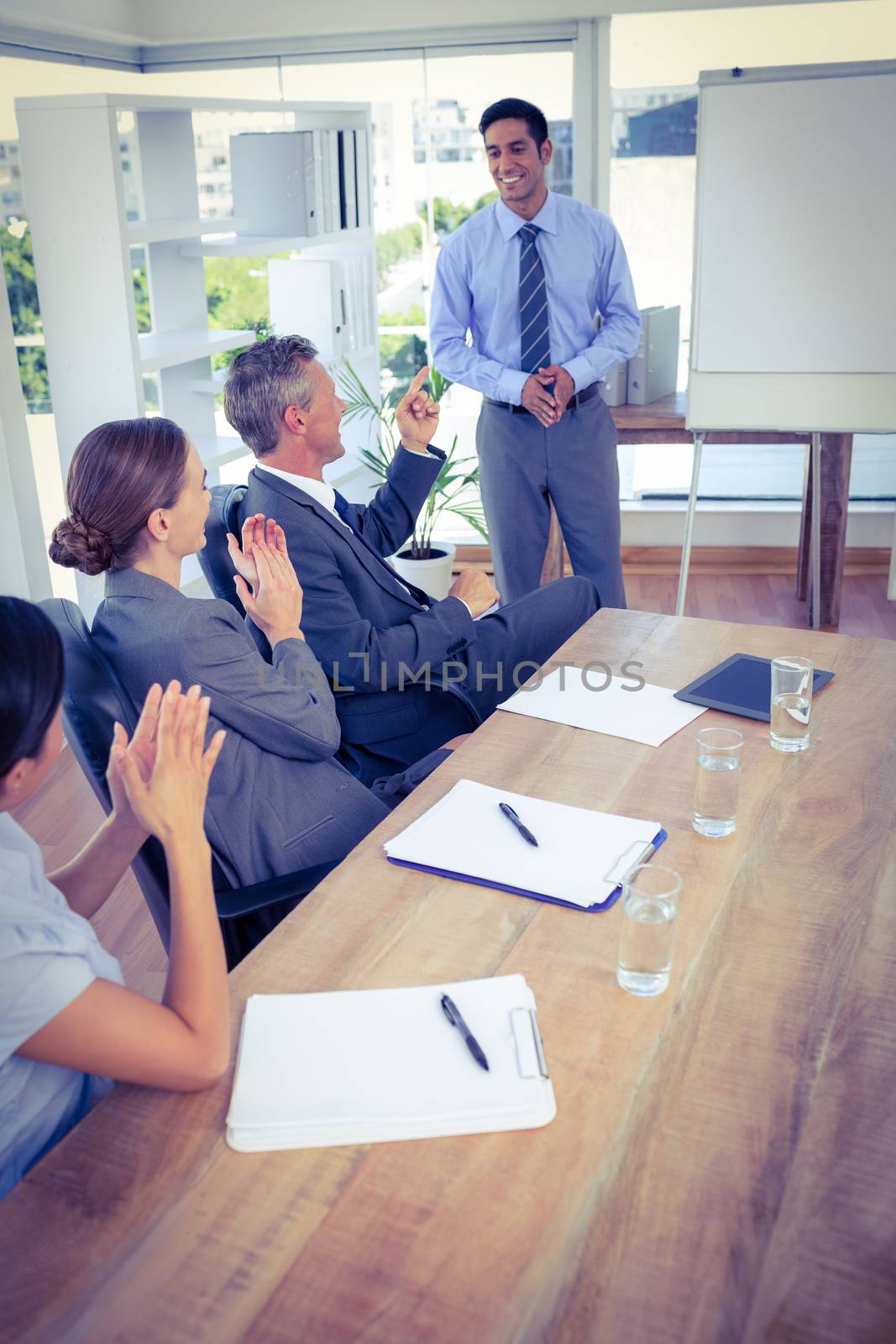 Business people applauding during a meeting by Wavebreakmedia