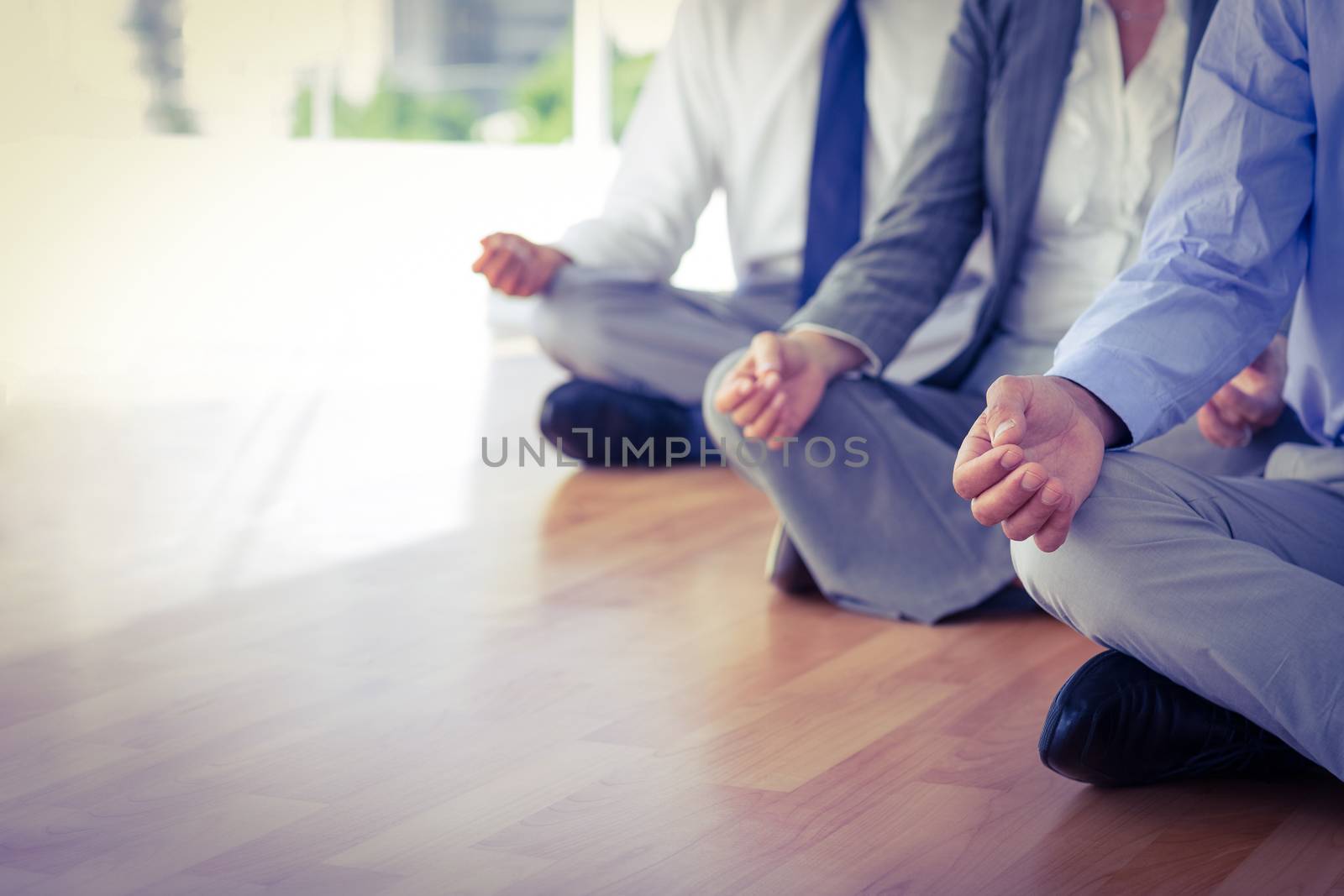 Close up view of business people doing yoga  by Wavebreakmedia