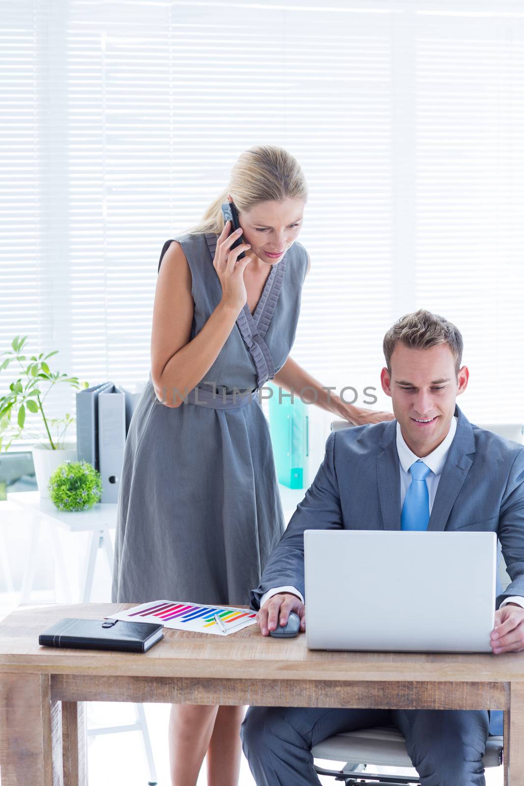 Business people working together on laptop in the office