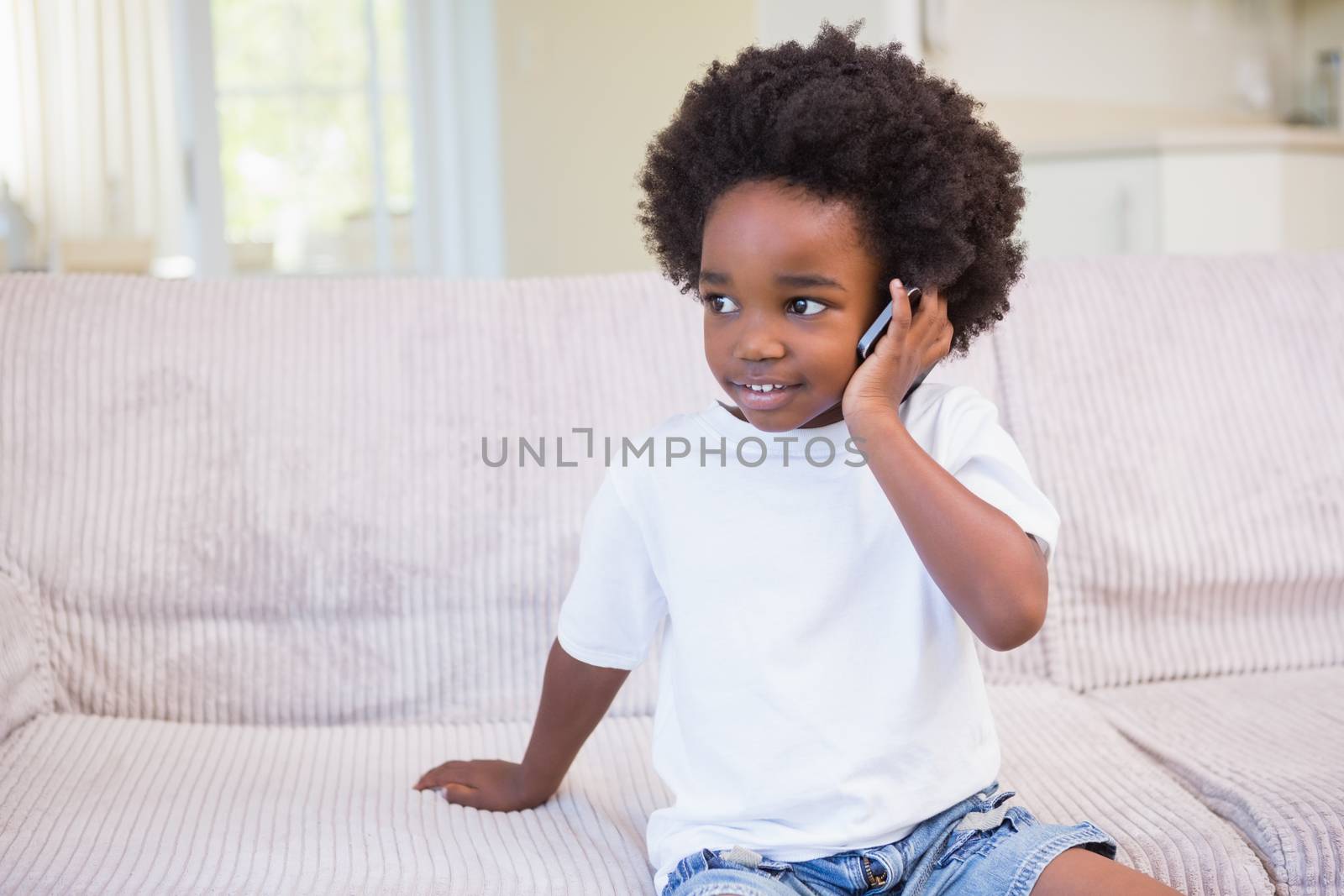 Portrait of a little boy using technology at home on bedroom