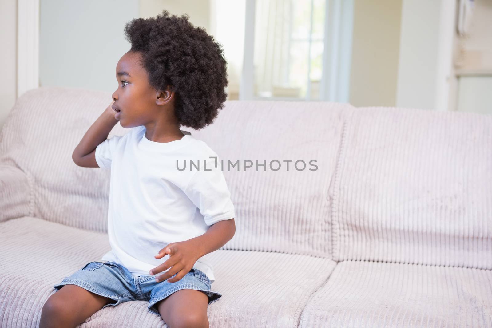 Little boy using a twechnology and phoning at home in bedroom 