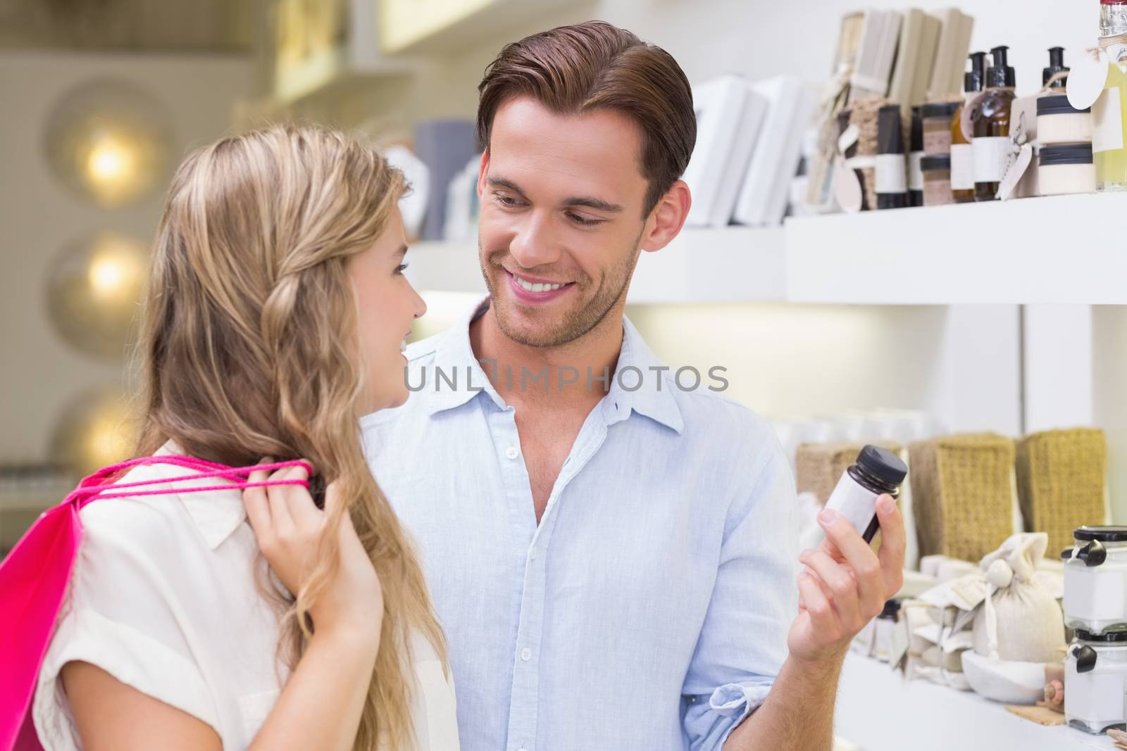 A couple testing a sample of beauty products in the mall