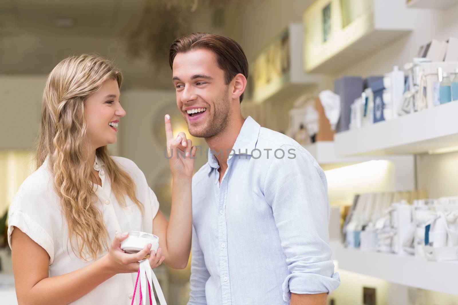 A couple testing a sample of beauty products in the mall