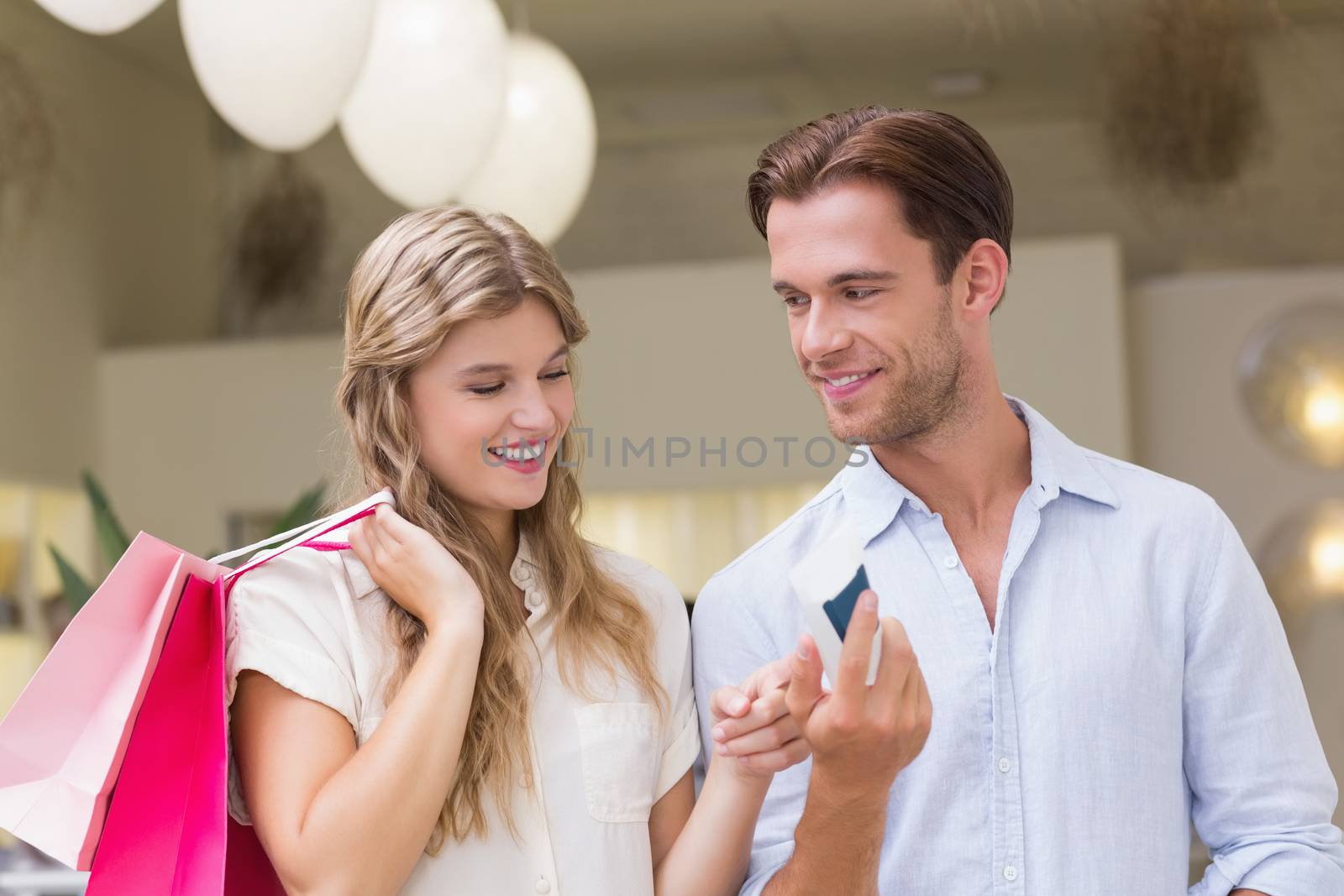 A happy couple looking at beauty product at the mall