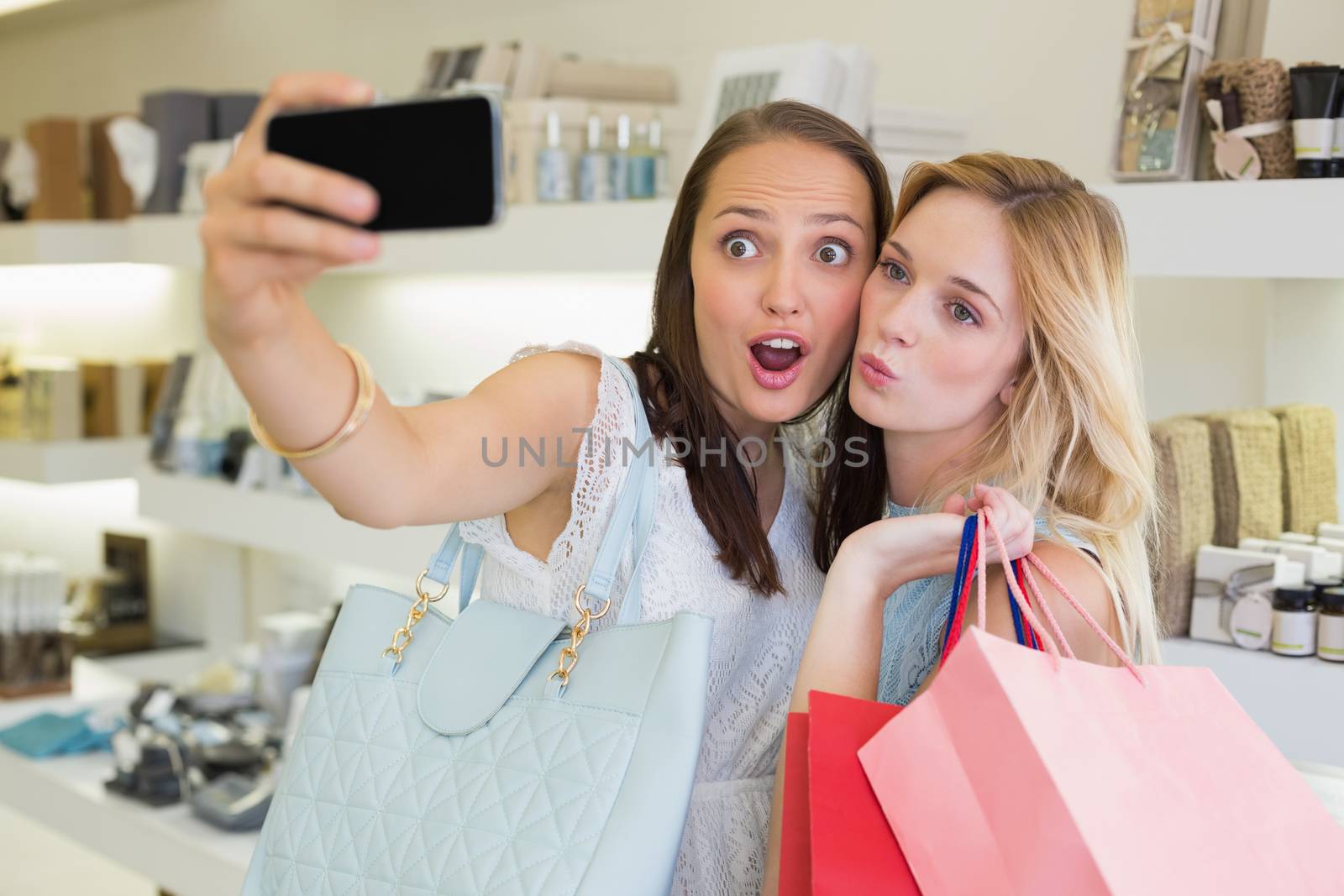 Happy women friends taking a selfie  by Wavebreakmedia