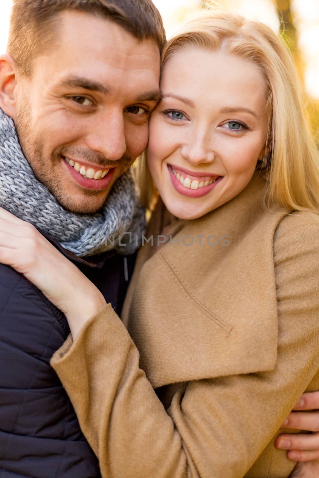 smiling couple hugging in autumn park by dolgachov