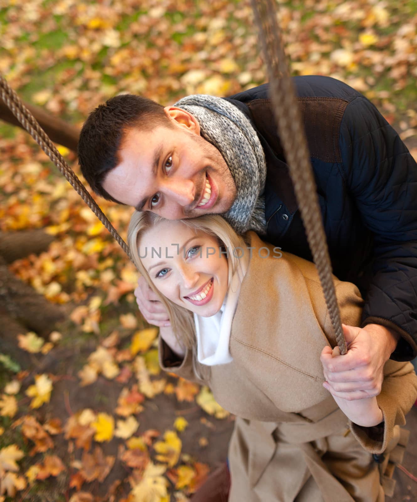 smiling couple hugging in autumn park by dolgachov