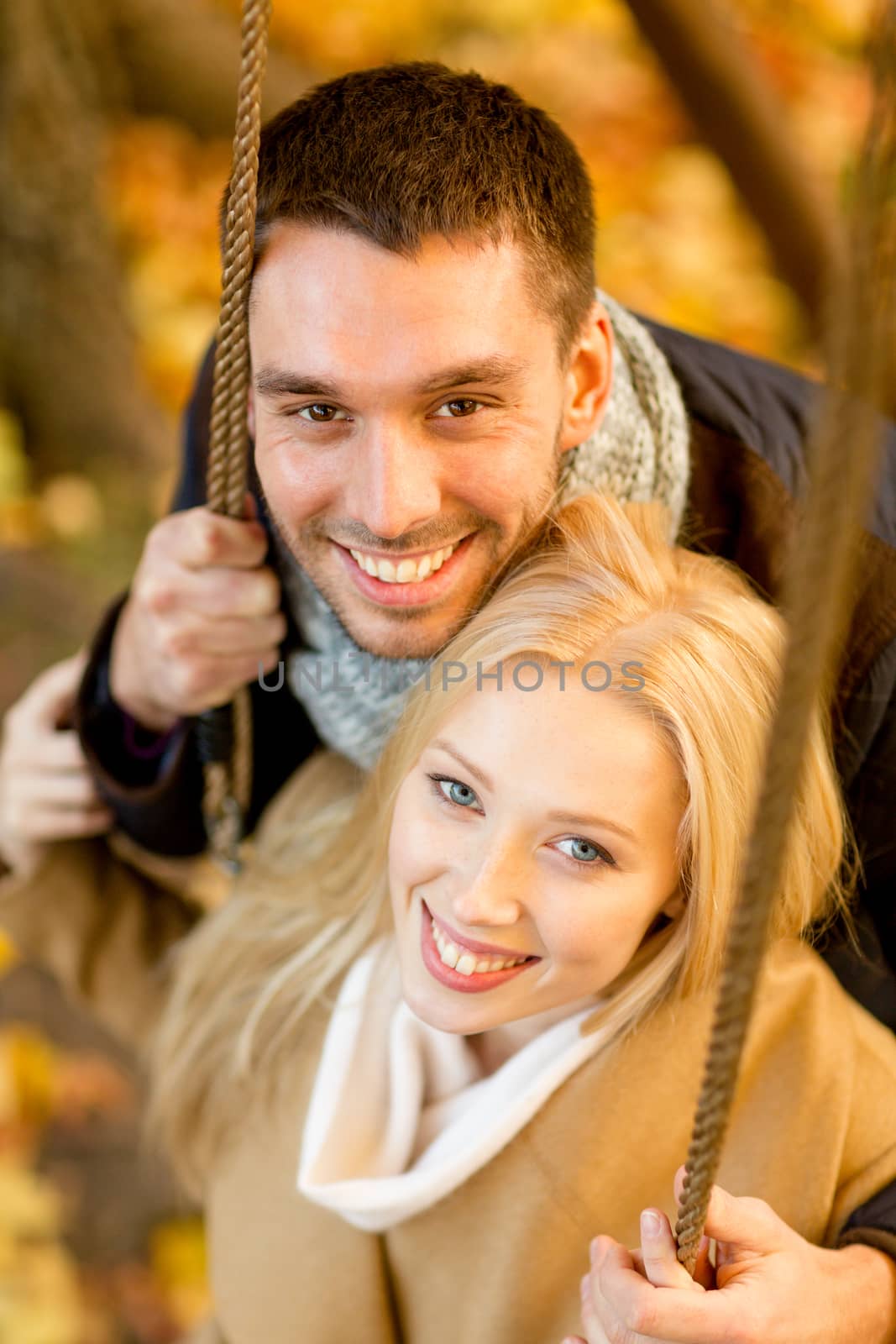 love, relationship, family and people concept - smiling couple hugging in autumn park