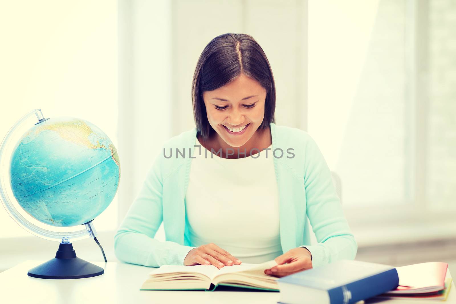 education and school, travel concept - female teacher with globe and book