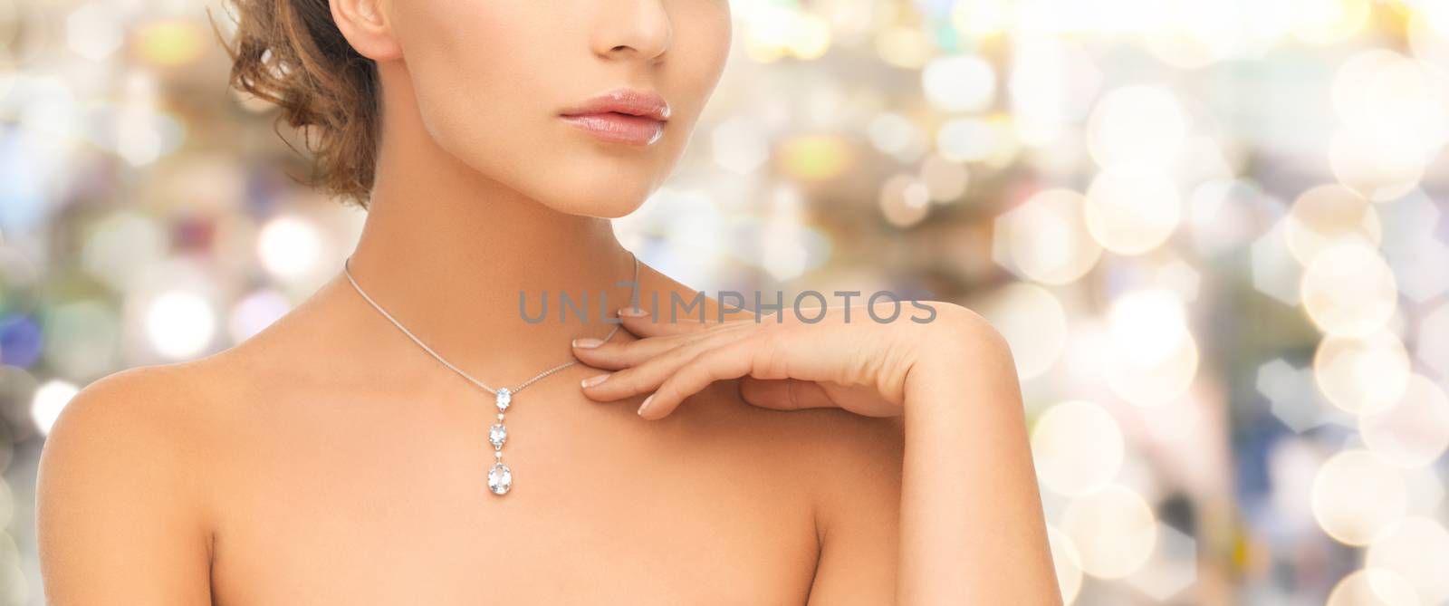 wedding, bridal, jewelry and luxury concept - beautiful woman wearing shiny diamond necklace