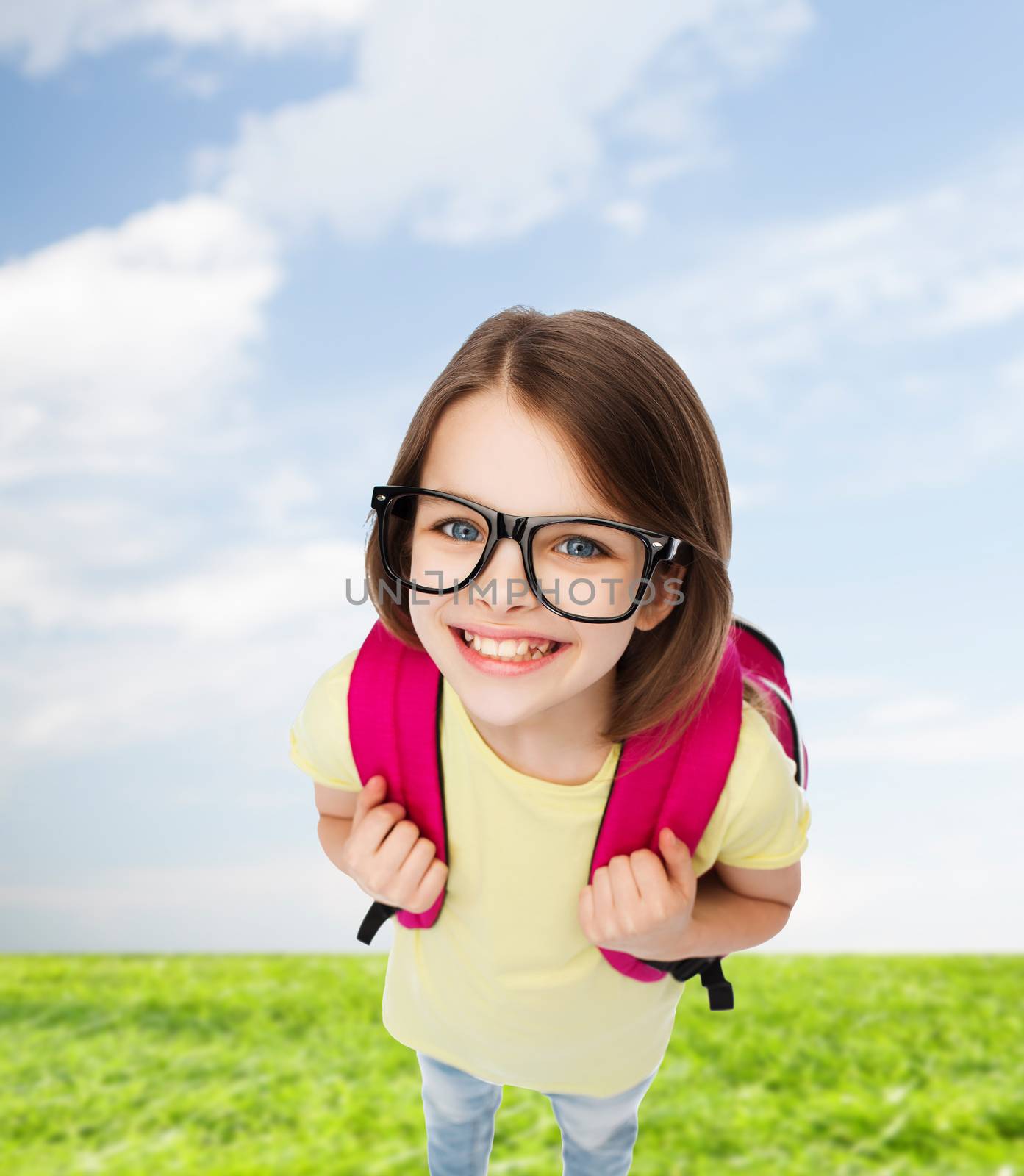 happy smiling teenage girl in eyeglasses with bag by dolgachov