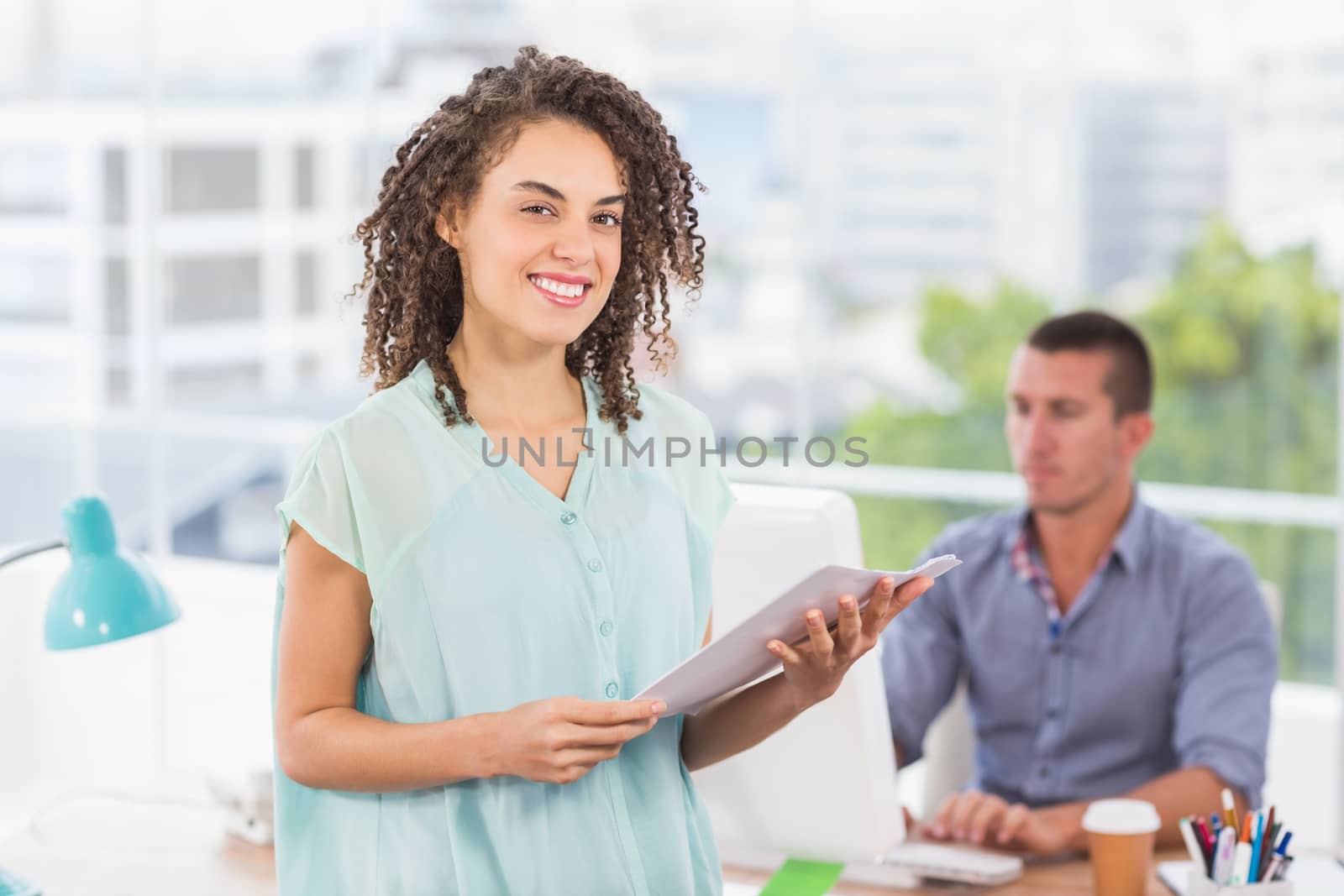 Portrait of a smiling businesswoman holding a notebook