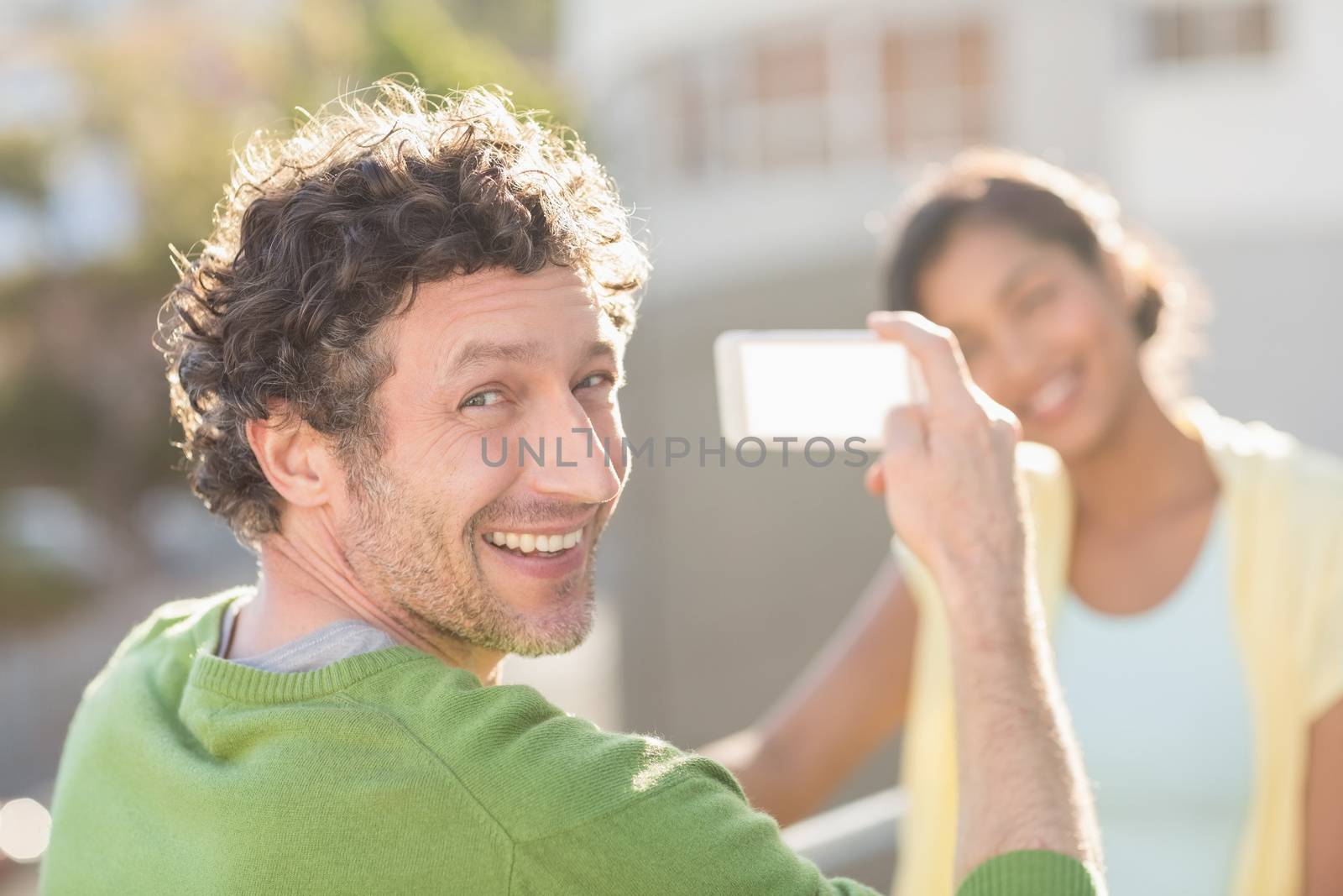 couple taking photos of themselves during the summer