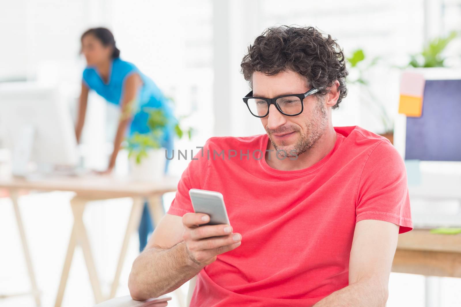 Man posing in front of his colleague in the office