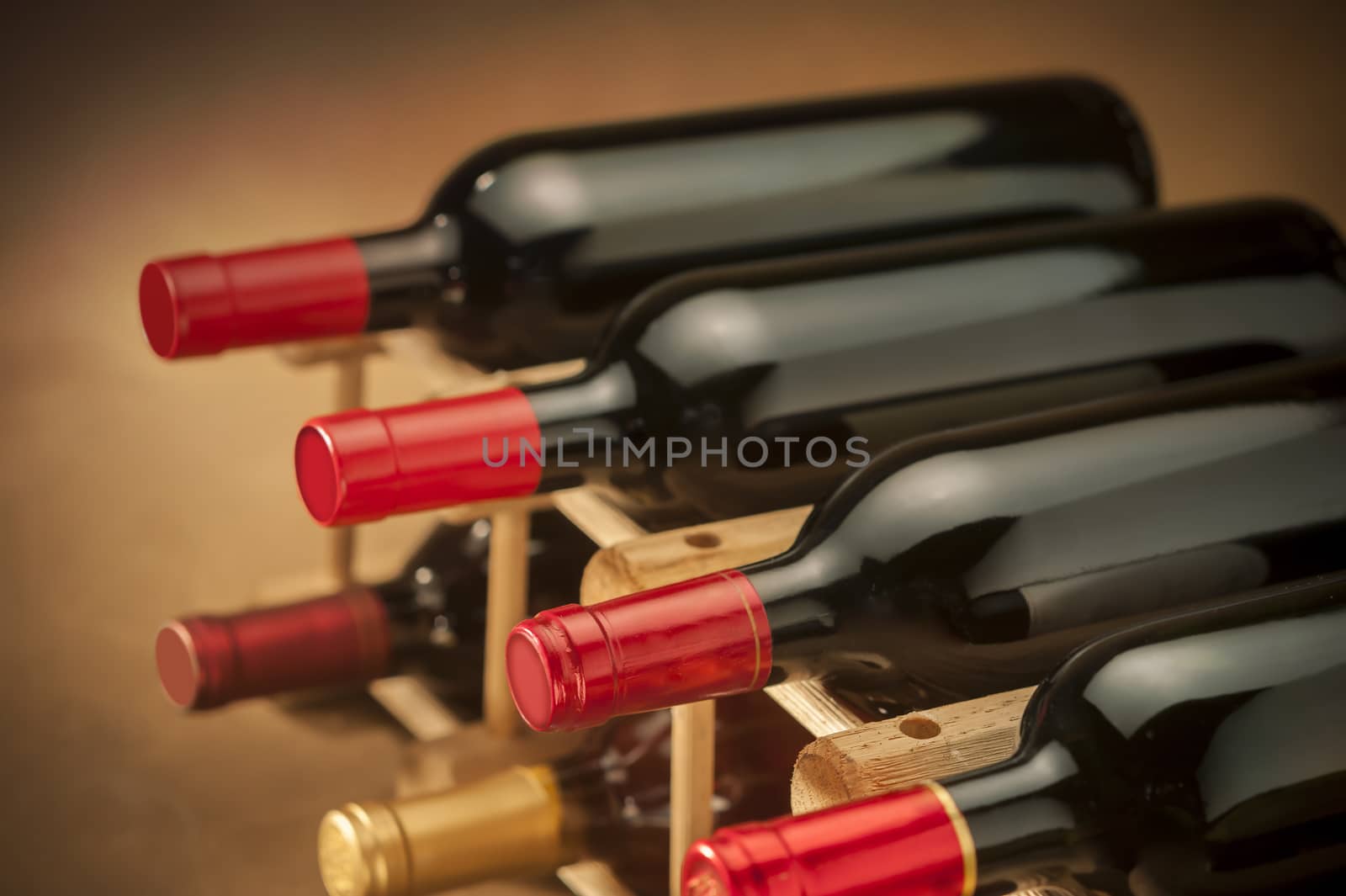 wine bottles stacked on wooden racks shot with limited depth of field