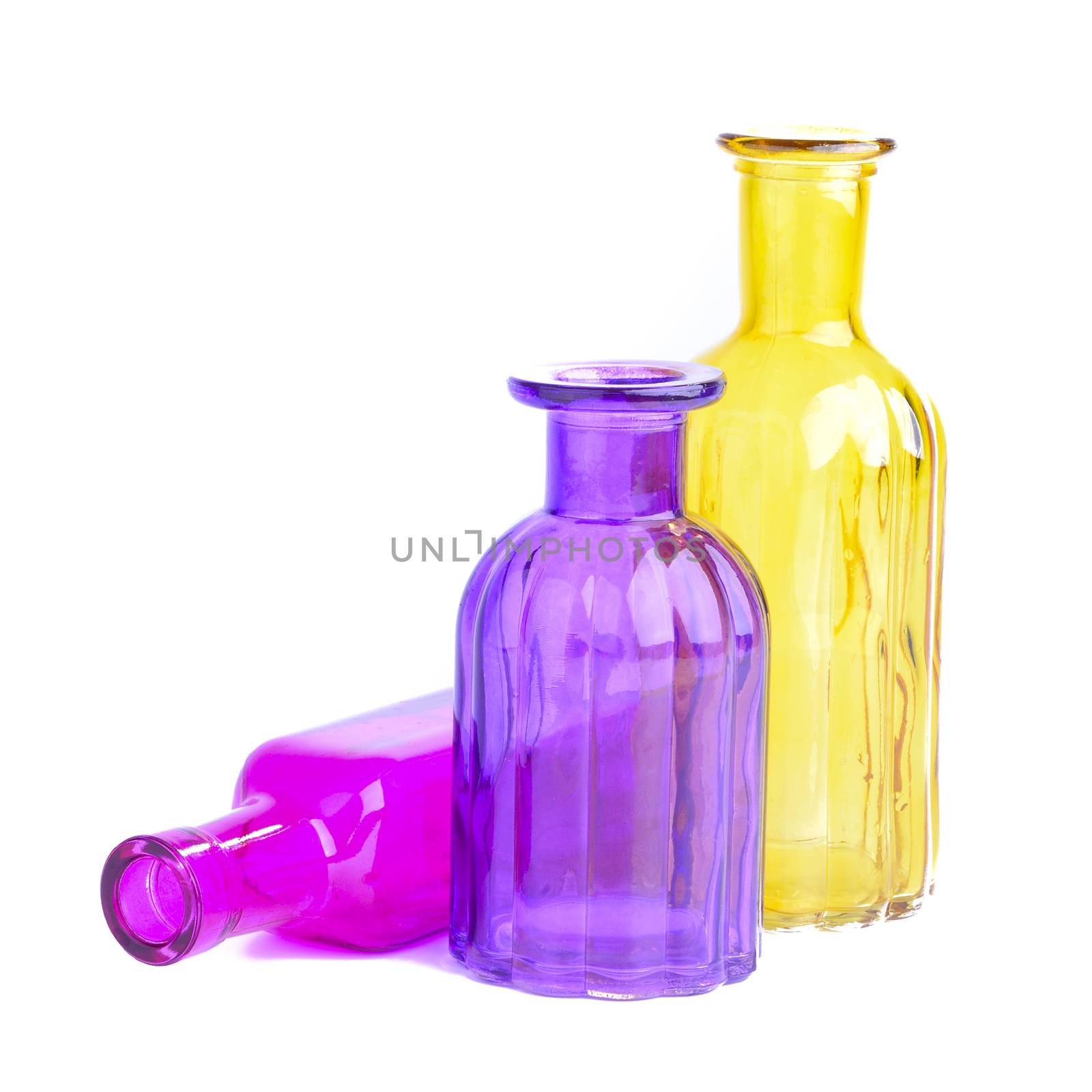 Three colorful bottles, isolated on white background