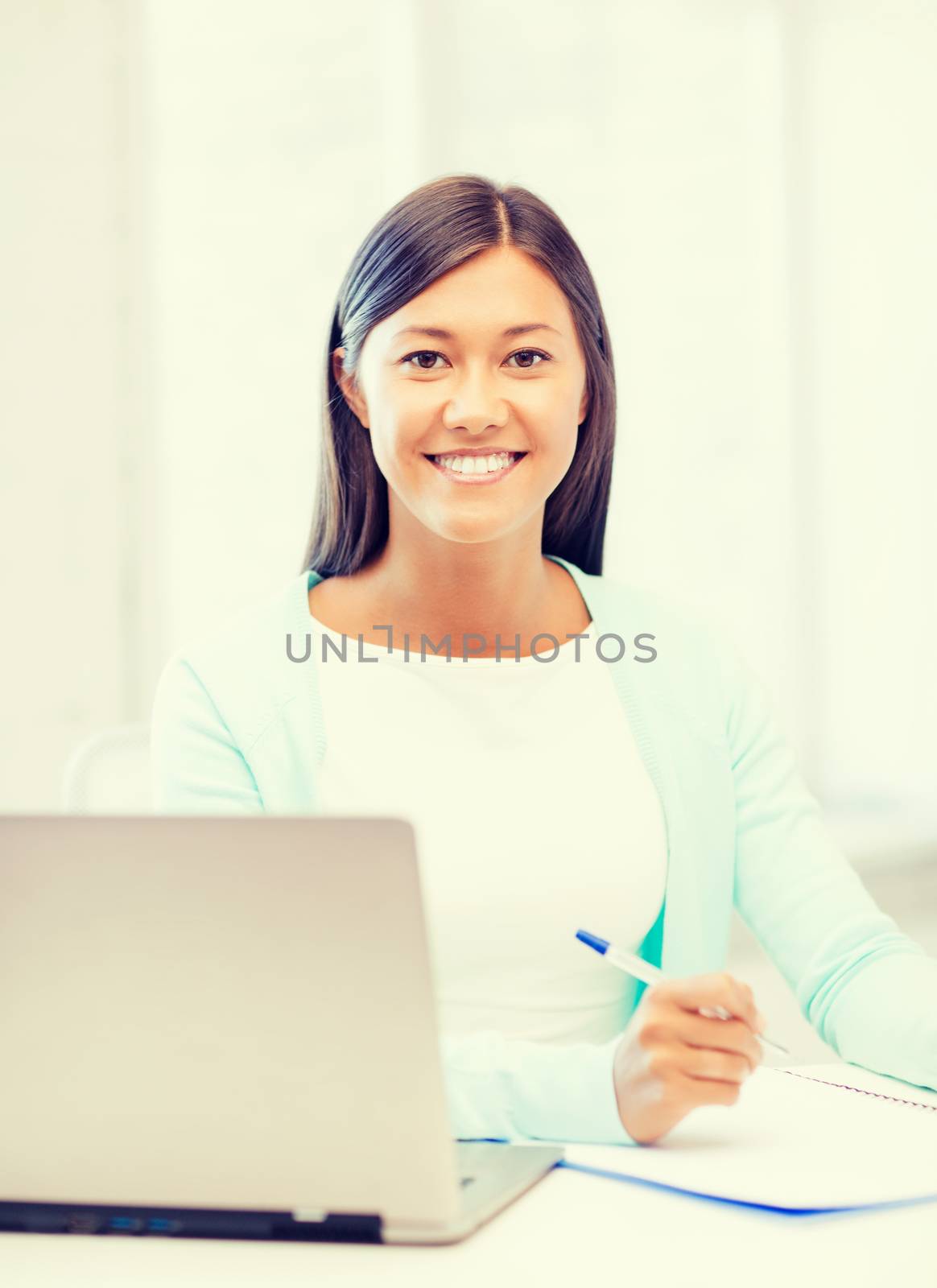 business, education and technology concept - asian businesswoman or student with laptop and documents in office