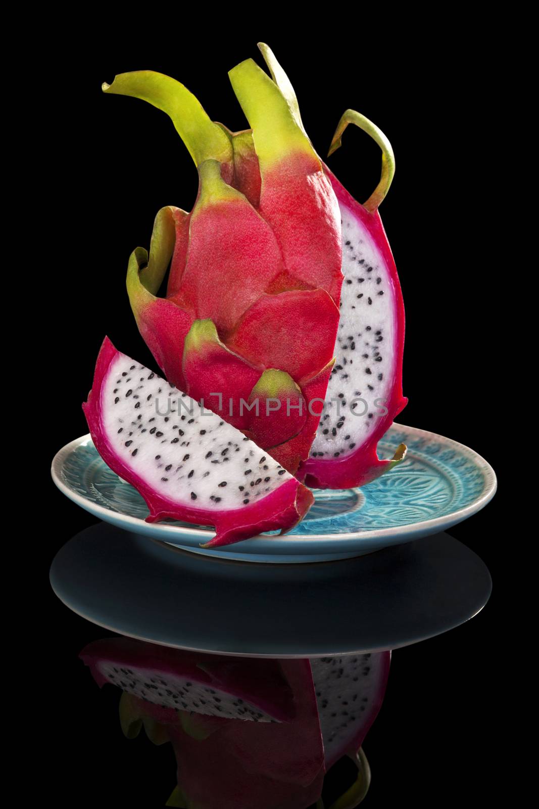 Luxurious dragon fruit isolated on black background. Tropical fruit, luxurious minimal style. 