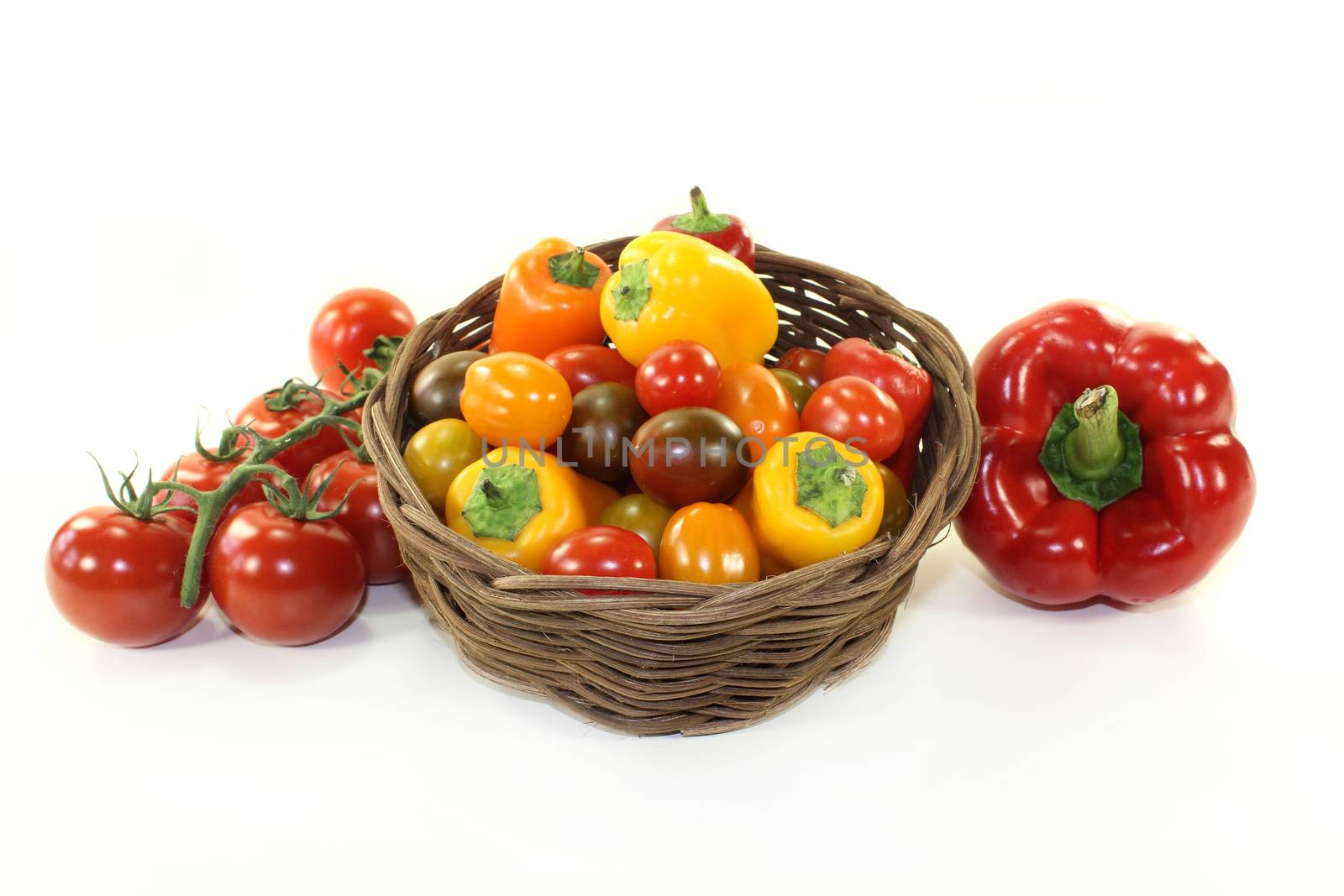 little tomatoes and peppers in a small basket