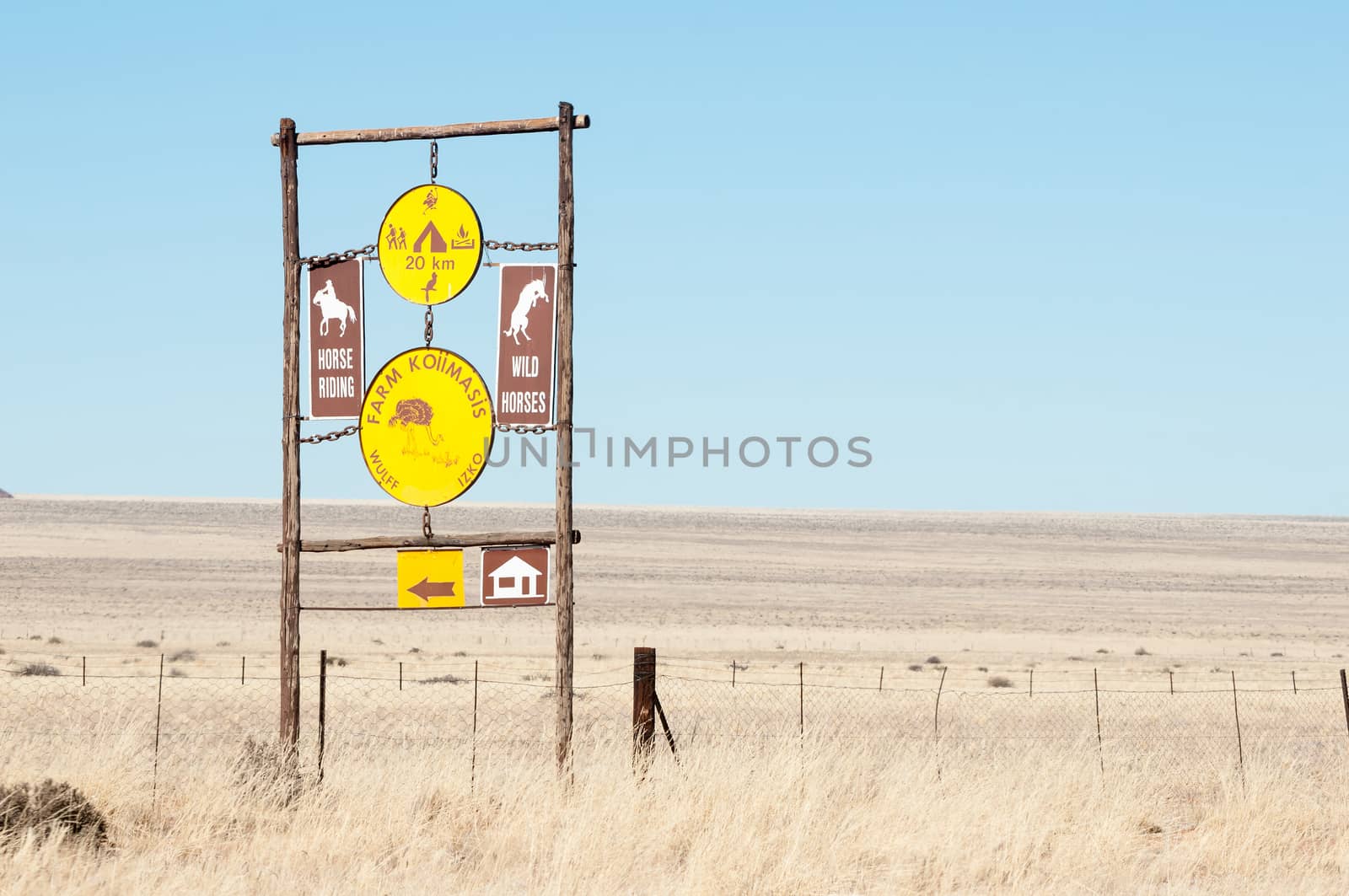 KOIIMASIS, NAMIBIA - JUNE 24, 2012: Sign post in the barren semi-desert area bordering the D707 road between Sesriem and Aus
