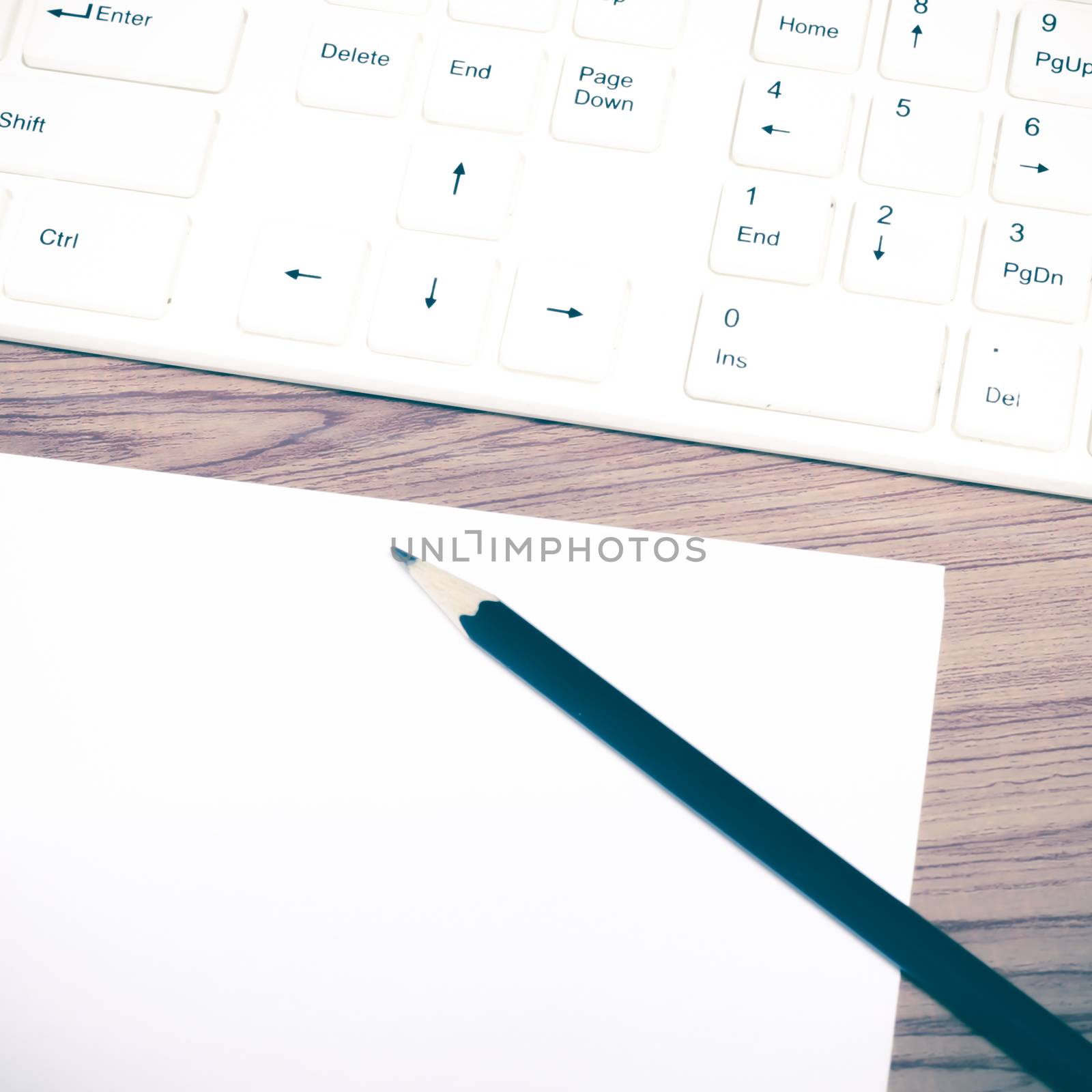 keyboard computee white paper and black pencil on wood background vintage style