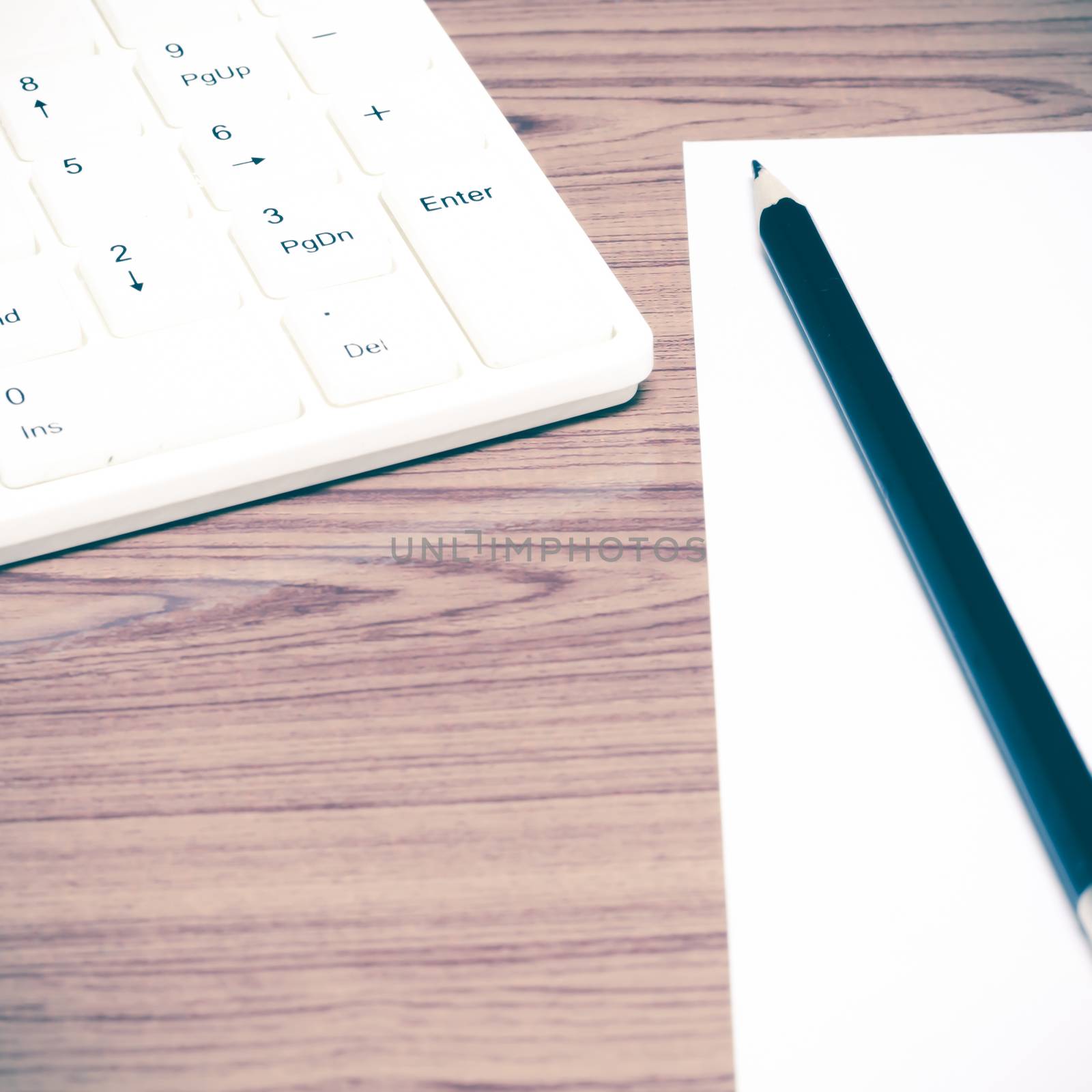 keyboard computee white paper and black pencil on wood background vintage style
