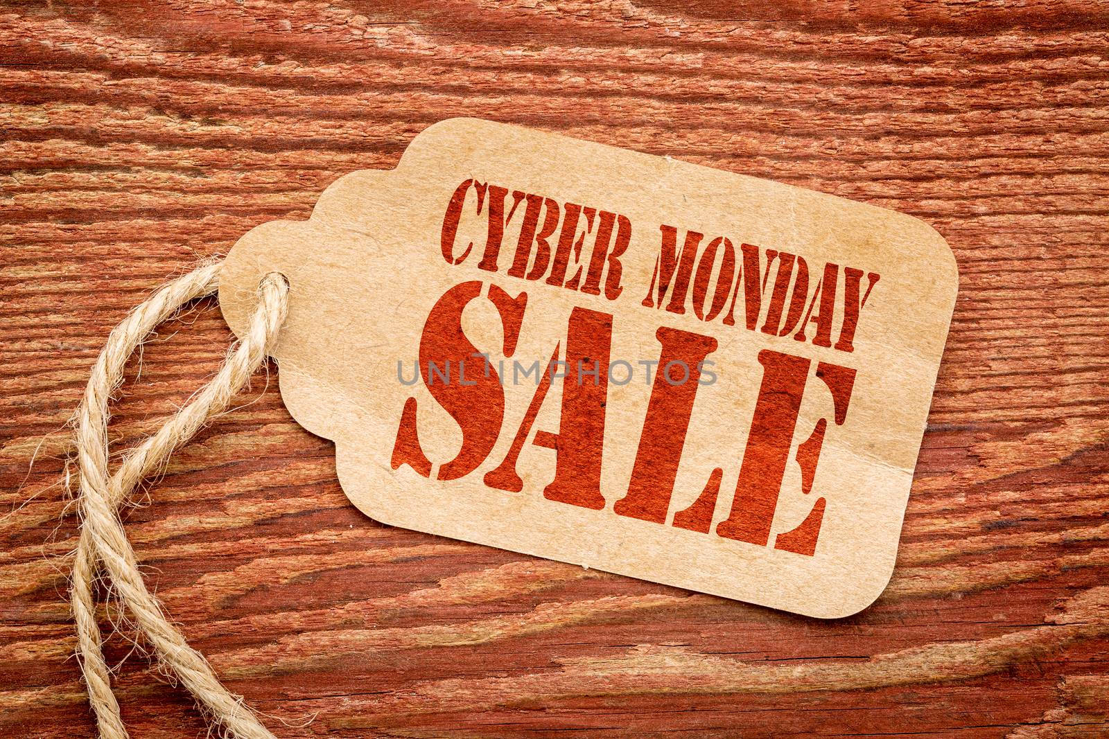 Cyber Monday  sale sign a paper price tag against rustic red painted barn wood