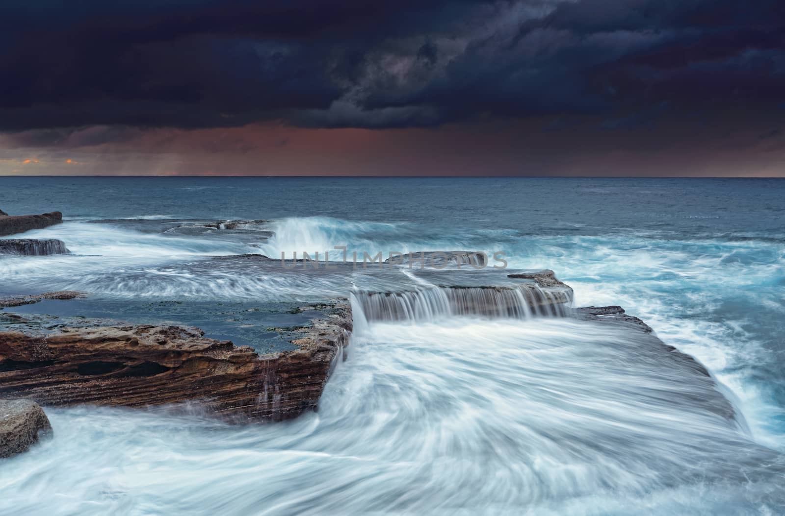 Stormy sunrise skies and turbulent seas at Maroubra