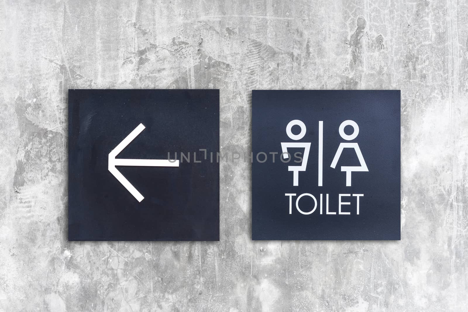 Unisex restroom or Toilet and arrow sign on concrete wall style boutique