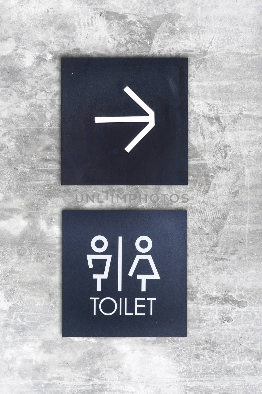 Unisex restroom or Toilet and arrow sign on concrete wall style boutique