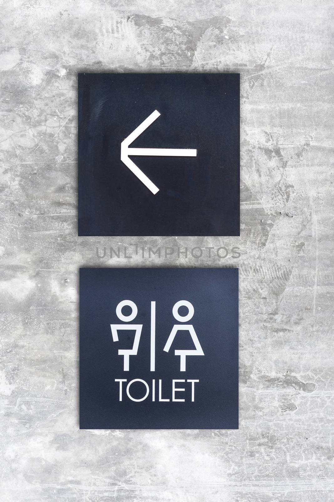 Unisex restroom or Toilet and arrow sign on concrete wall style boutique