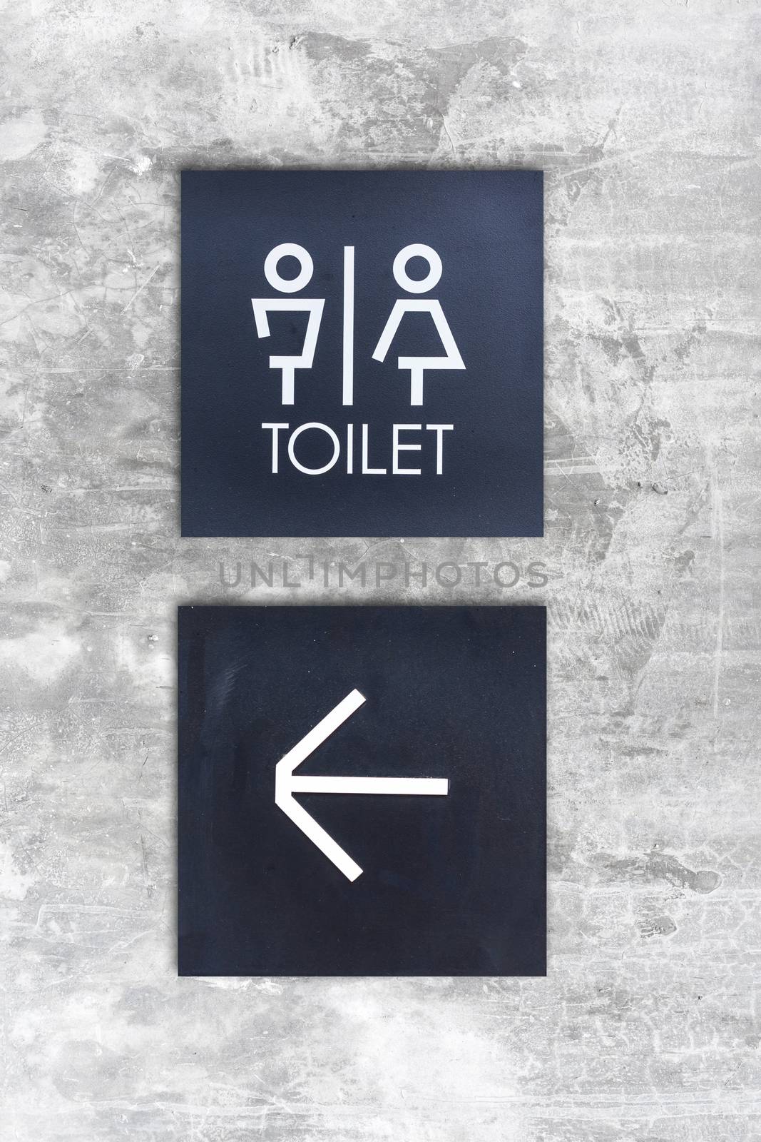 Unisex restroom or Toilet and arrow sign on concrete wall style boutique by nopparats