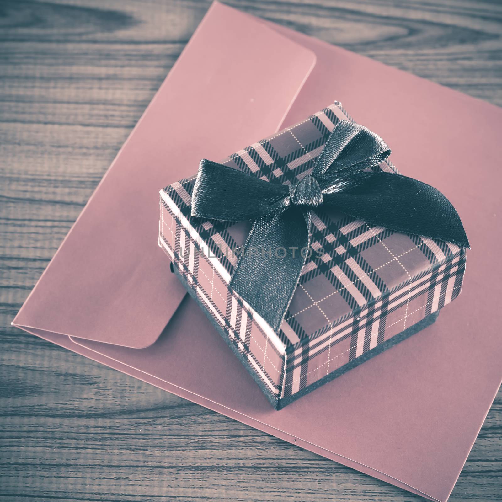 red gift box and envelope on wood background