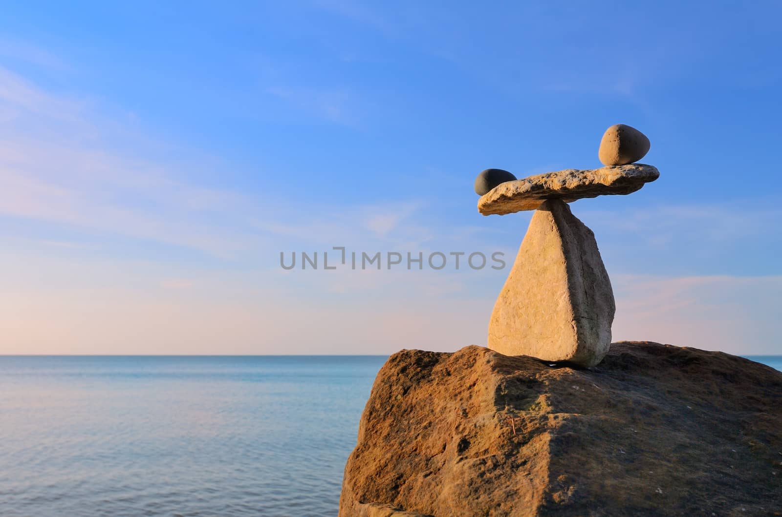 Well-balanced of pebbles on the top of boulder