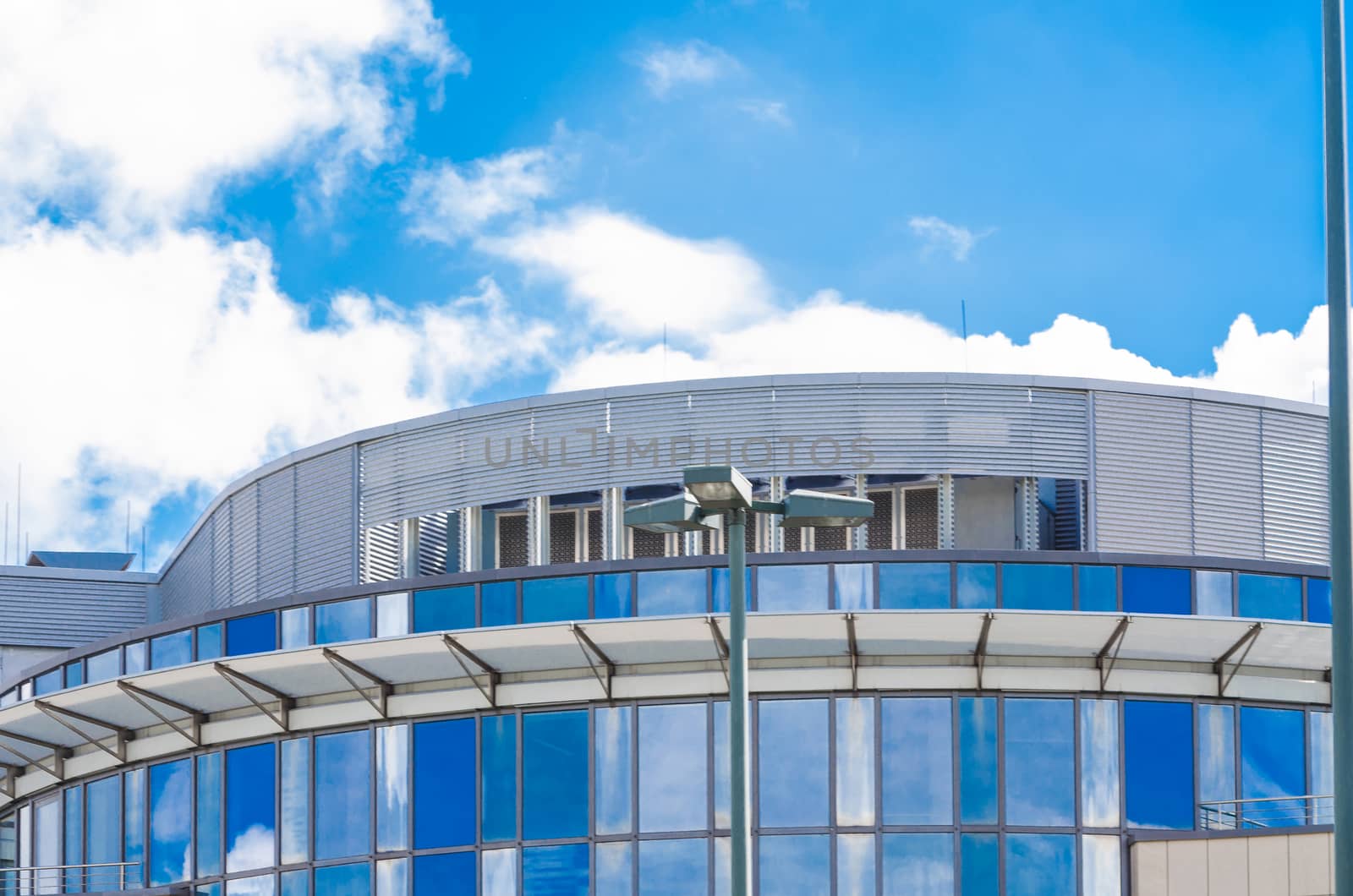 Clouds reflected in the windows of a modern office building.